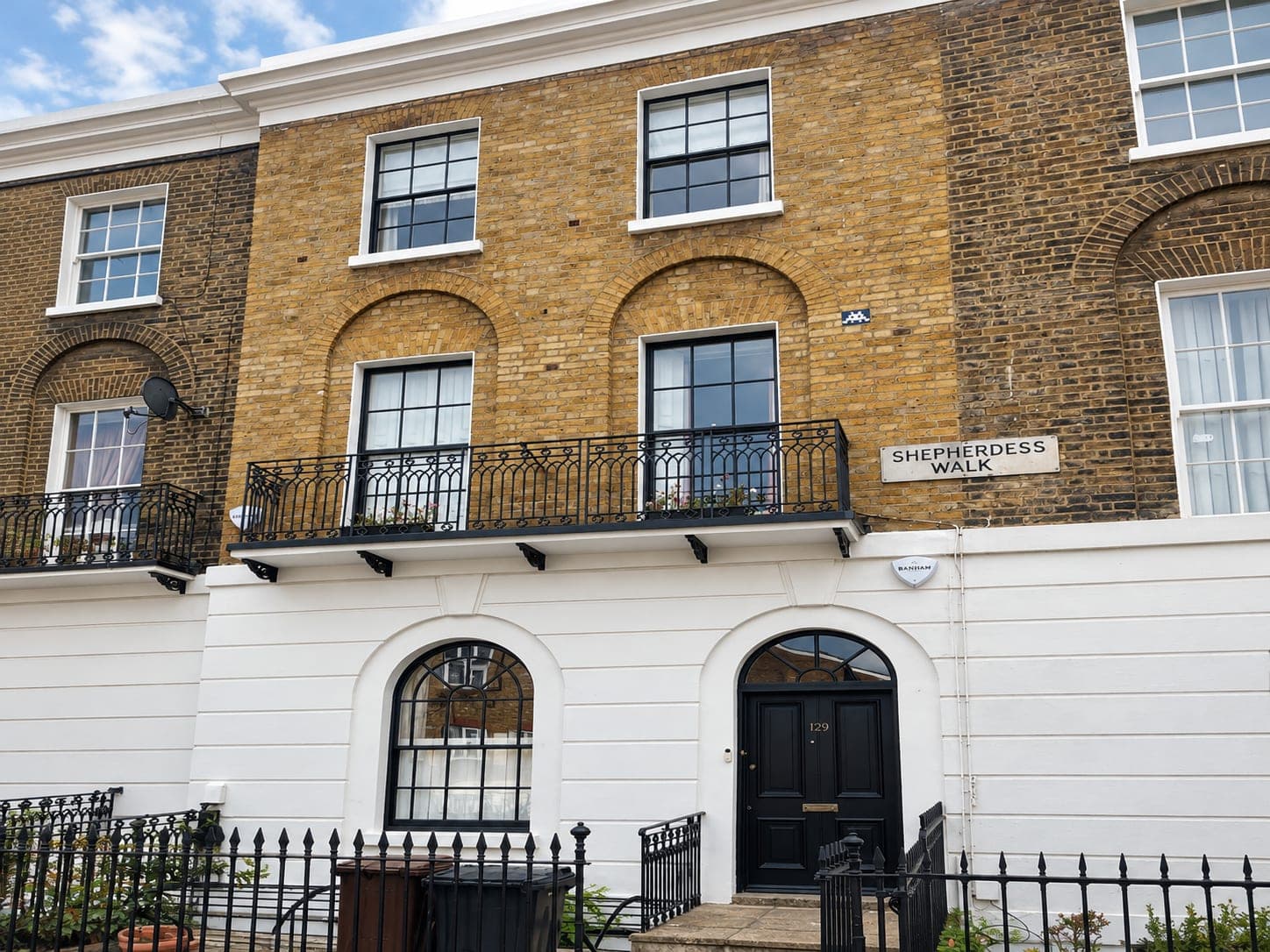 Restored facades along the terrace with arched doorways and reinstated cornice, Shepherdess Walk N1