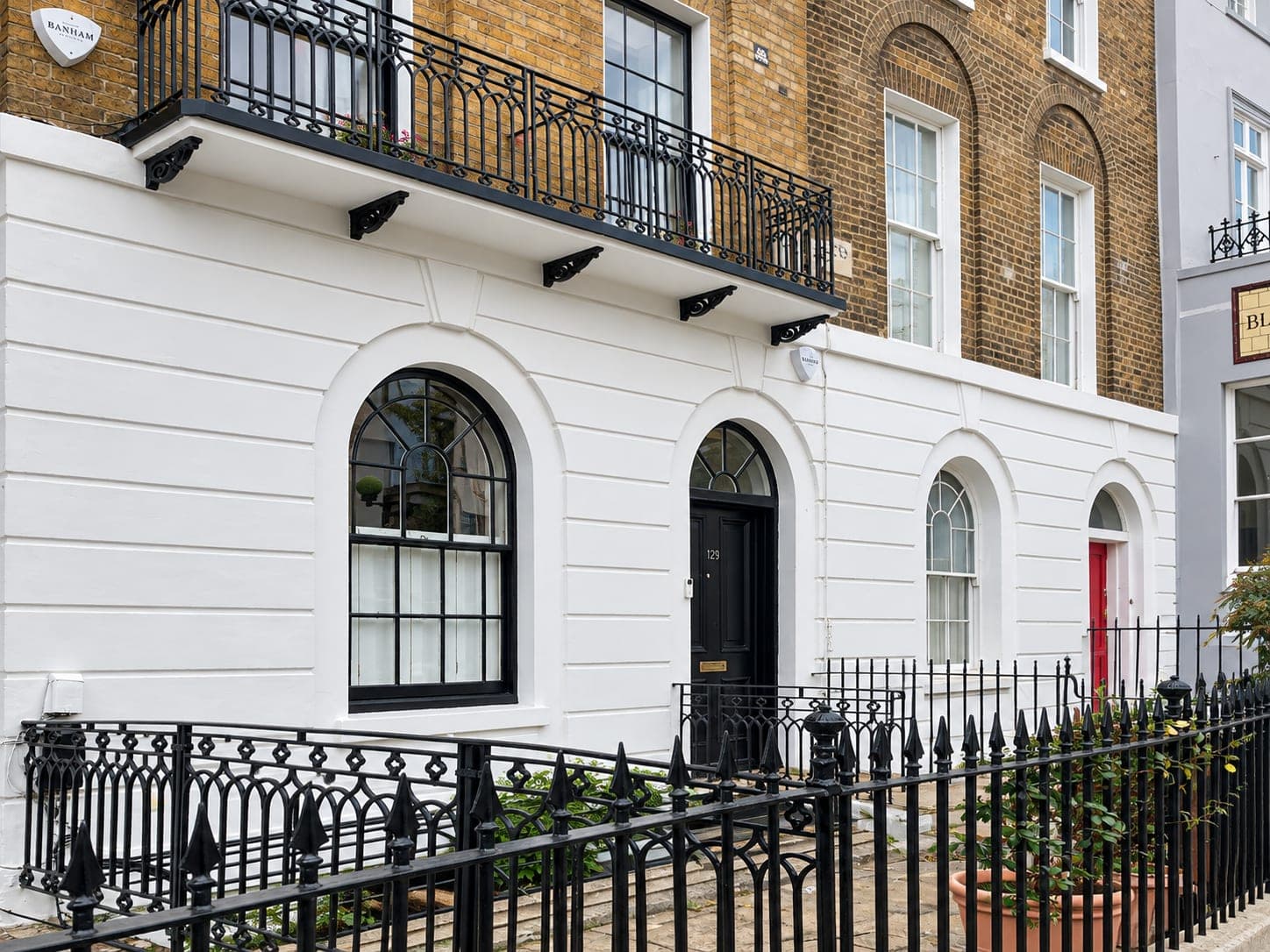Finished stucco and railings with the balcony brackets repainted, Shepherdess Walk N1