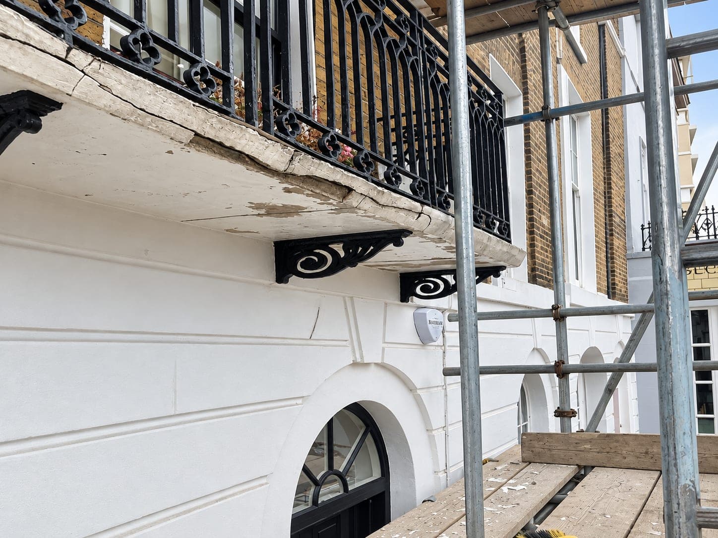 Balcony underside and brackets with the stucco broken away, Shepherdess Walk N1