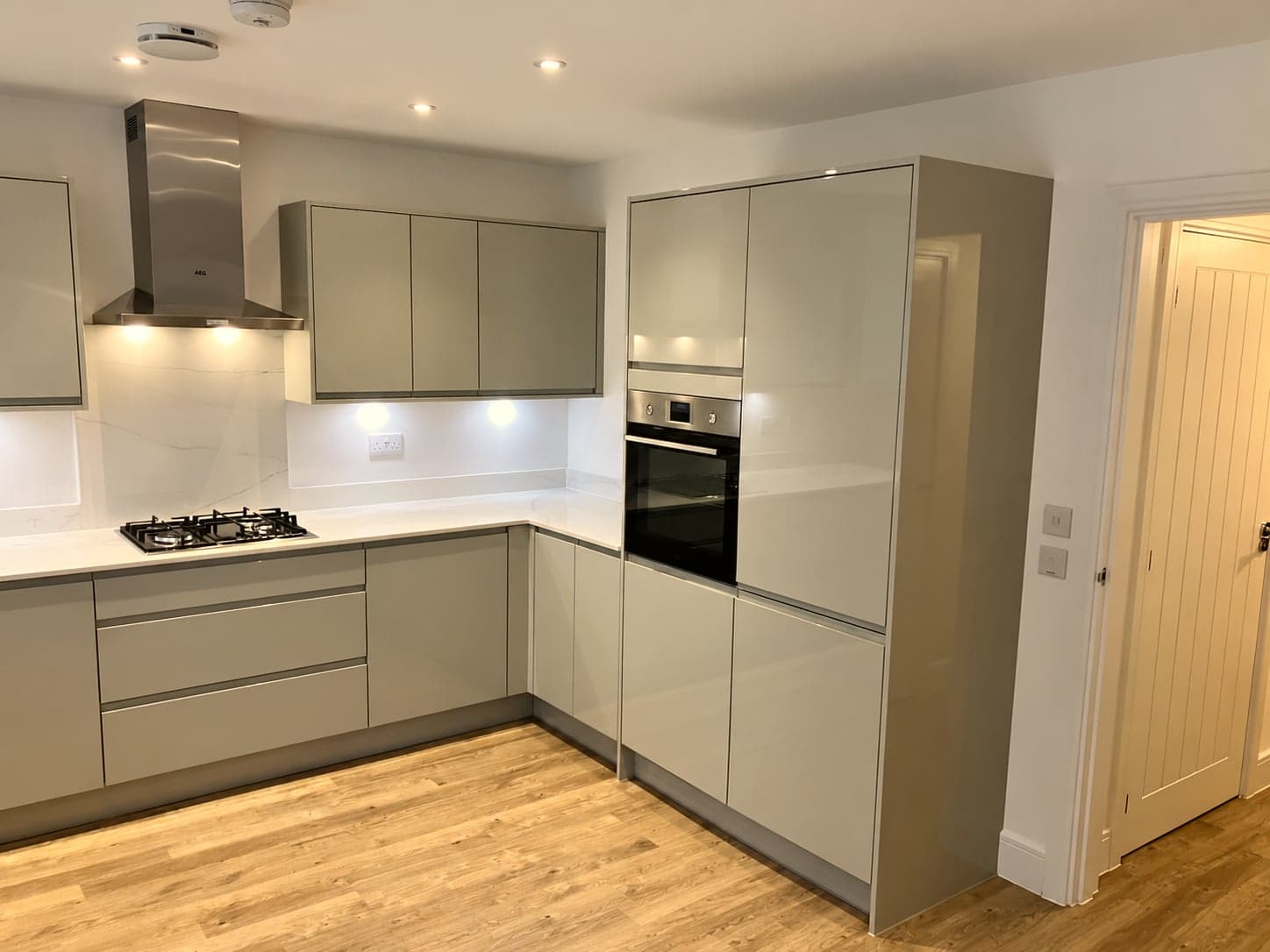 Kitchen run with chimney extractor, integrated oven tower and under-cabinet lighting, Hampstead NW3