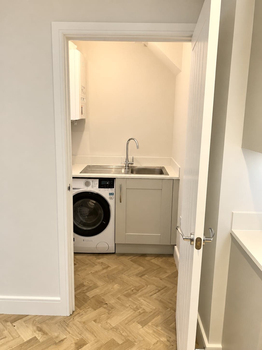 Utility room with sink and washing machine seen through the doorway, Amersham HP6
