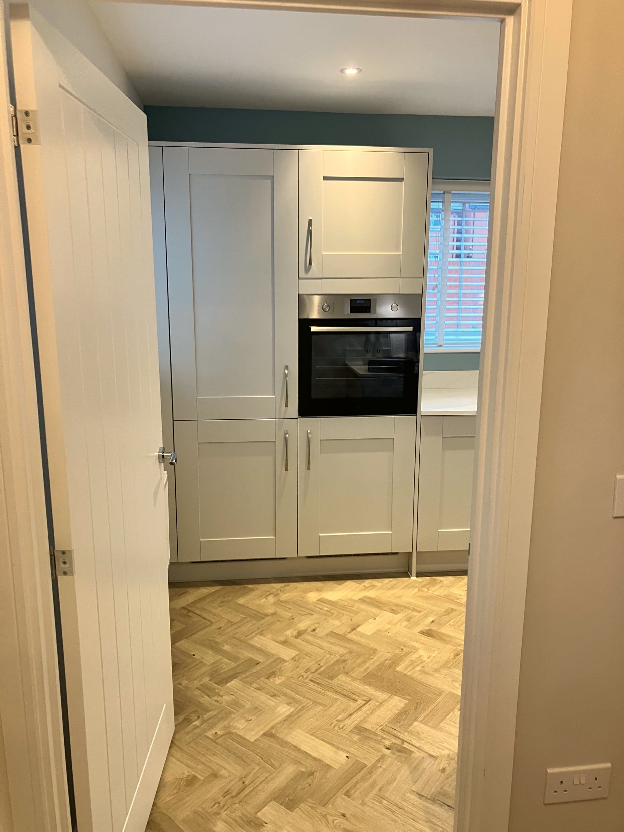 Kitchen from the doorway with oven tower and shuttered window, Amersham HP6