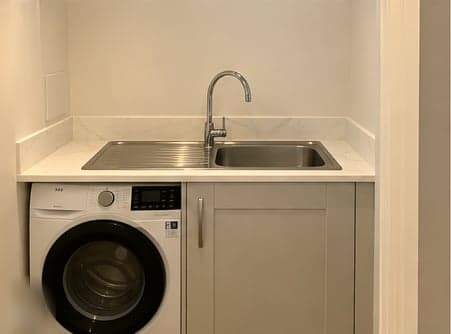 Utility worktop with inset sink and washing machine beneath, Amersham HP6