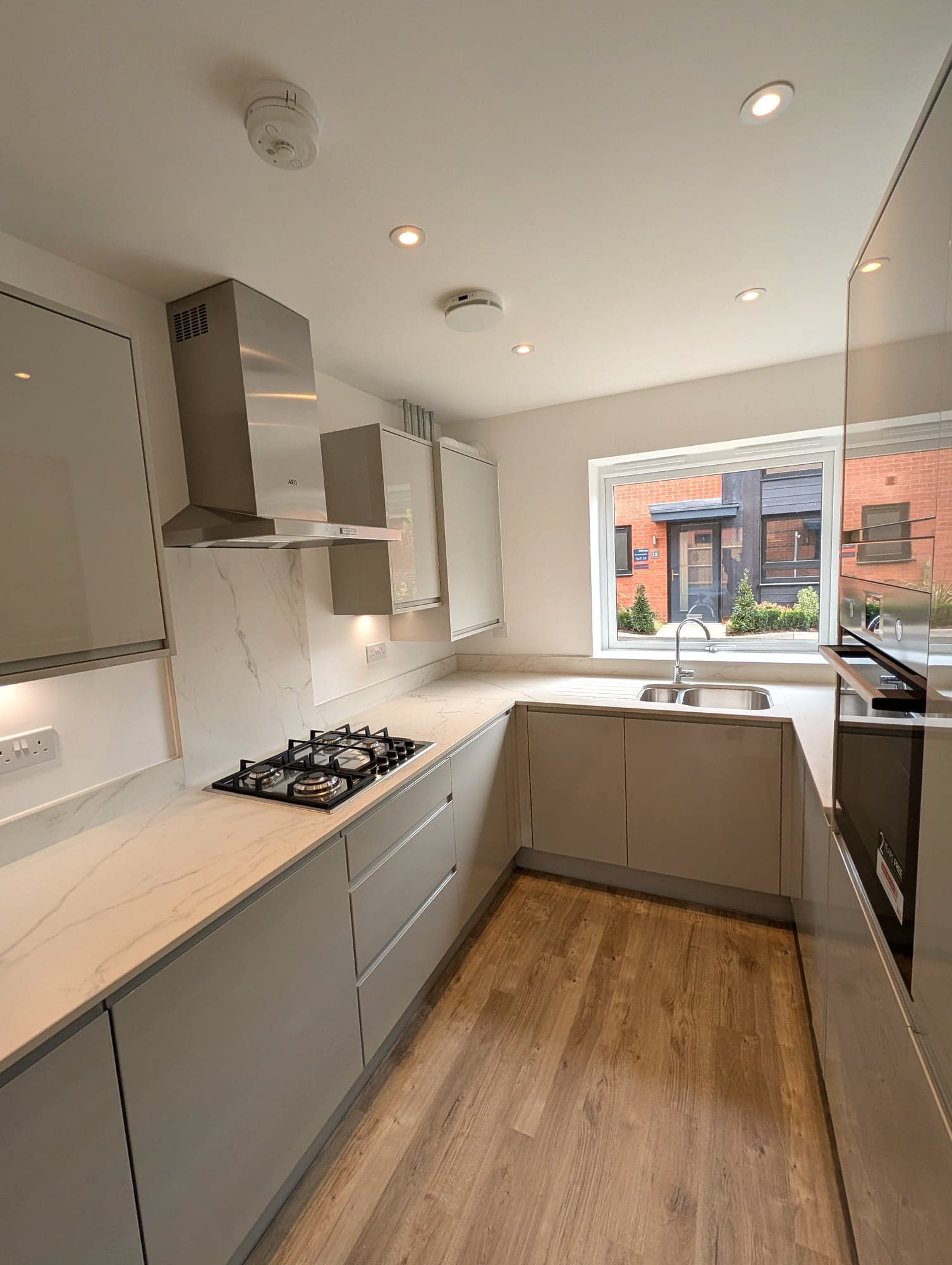 Galley layout with hob under the extractor and sink below the window, Barnet EN5