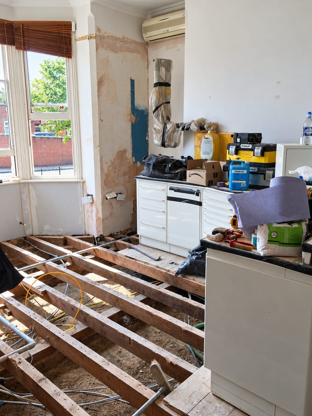 Mid-strip-out with the floor open and units being removed, Haverhill CB9