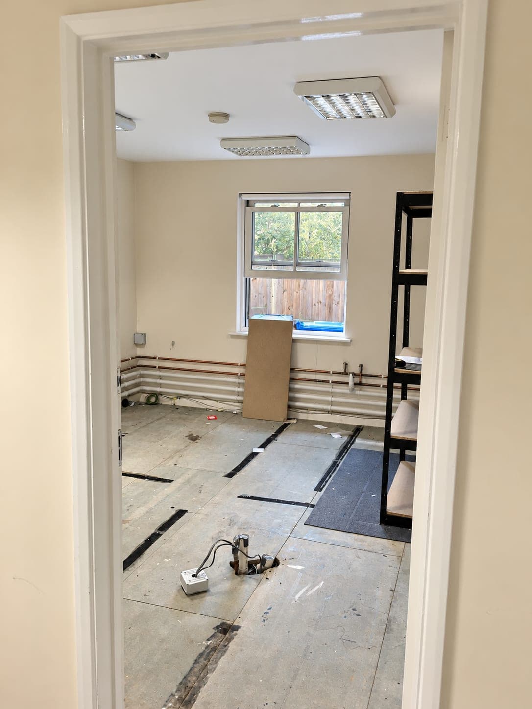 Room stripped out with floor lifted and services run along the wall, Haverhill CB9