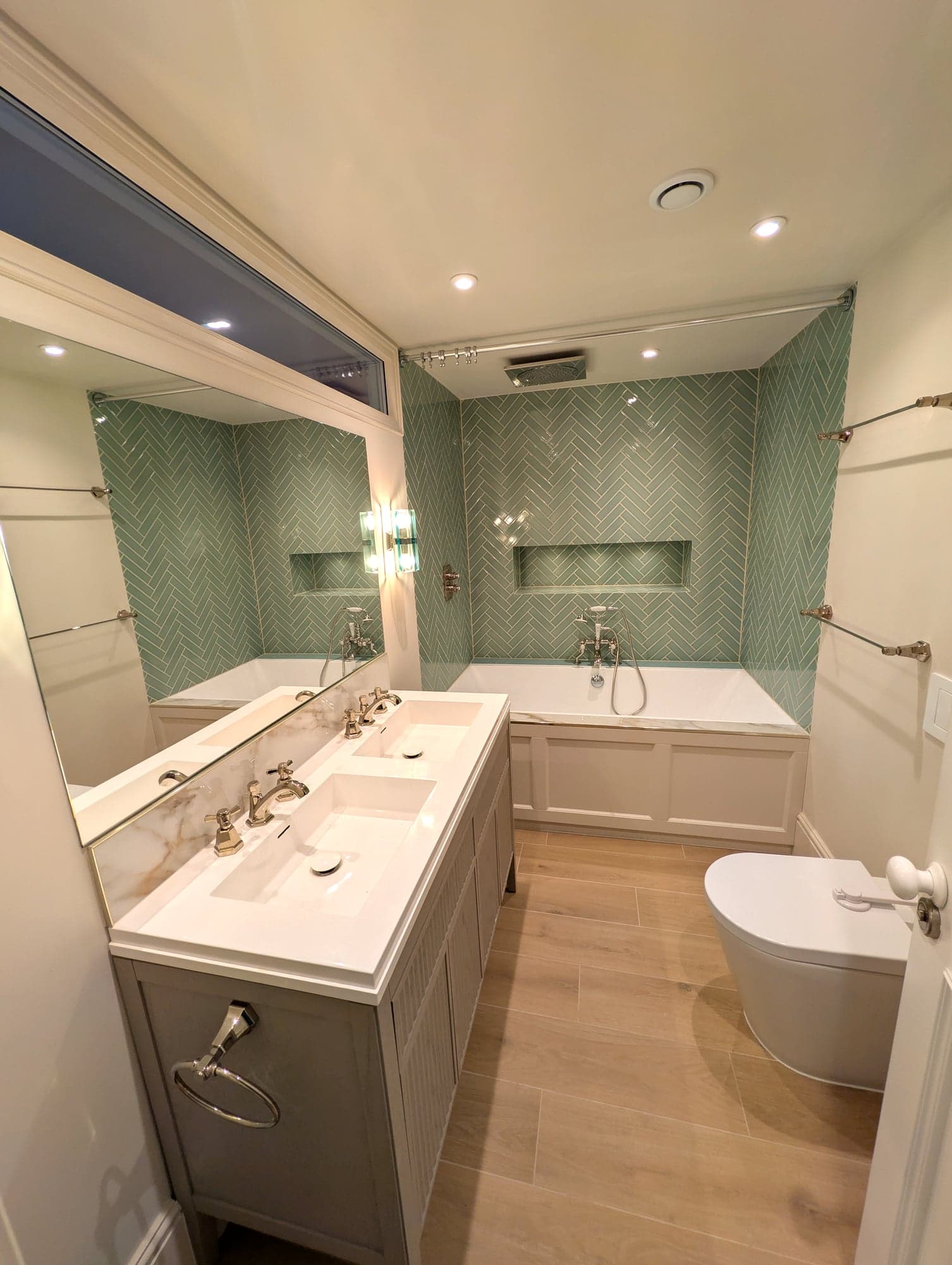Full view from the door: mirrored vanity wall, bath alcove and wall-hung WC, Fulham SW6