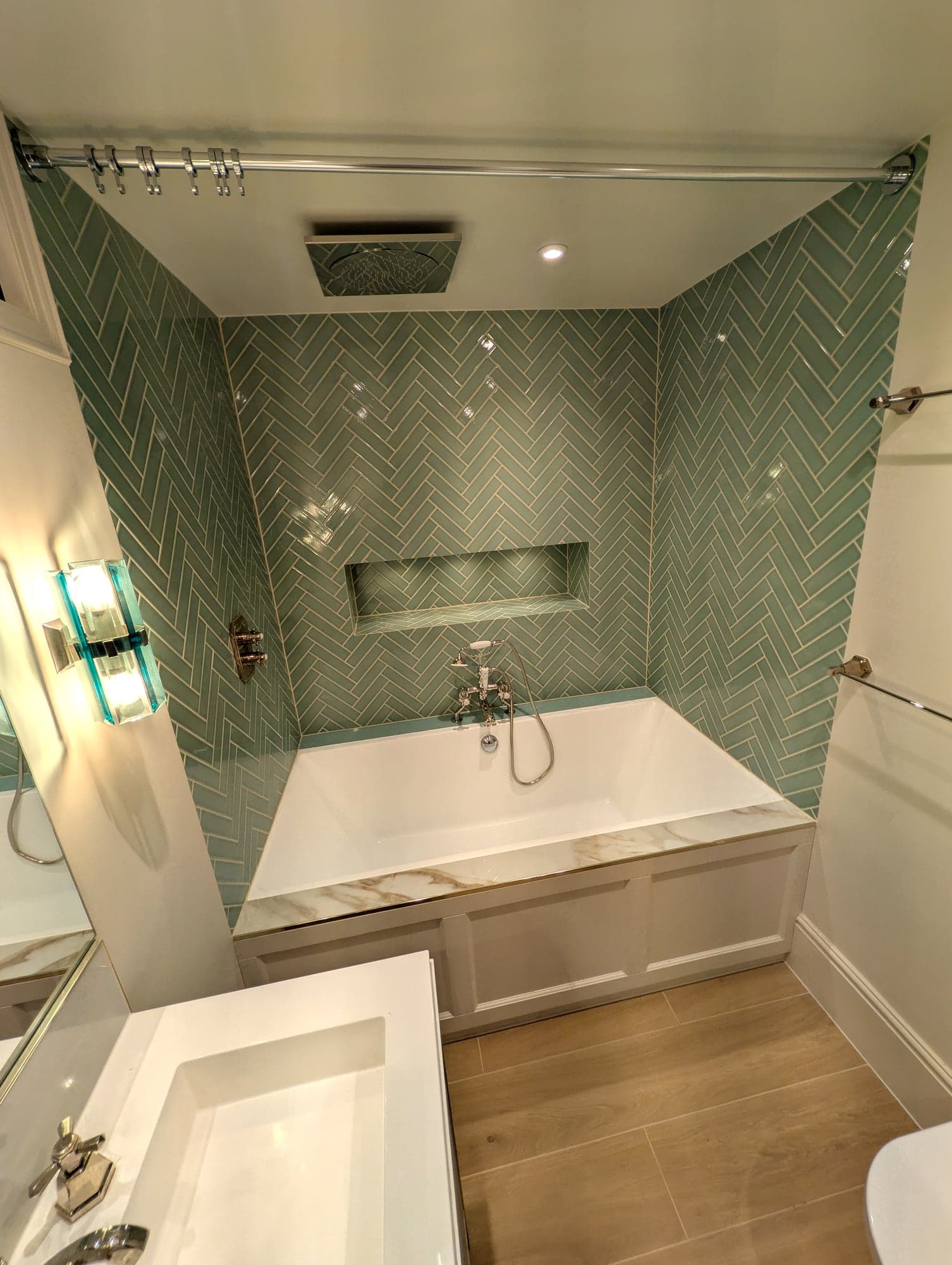 Bath and recessed niche reflected in the full-width vanity mirror, Fulham SW6