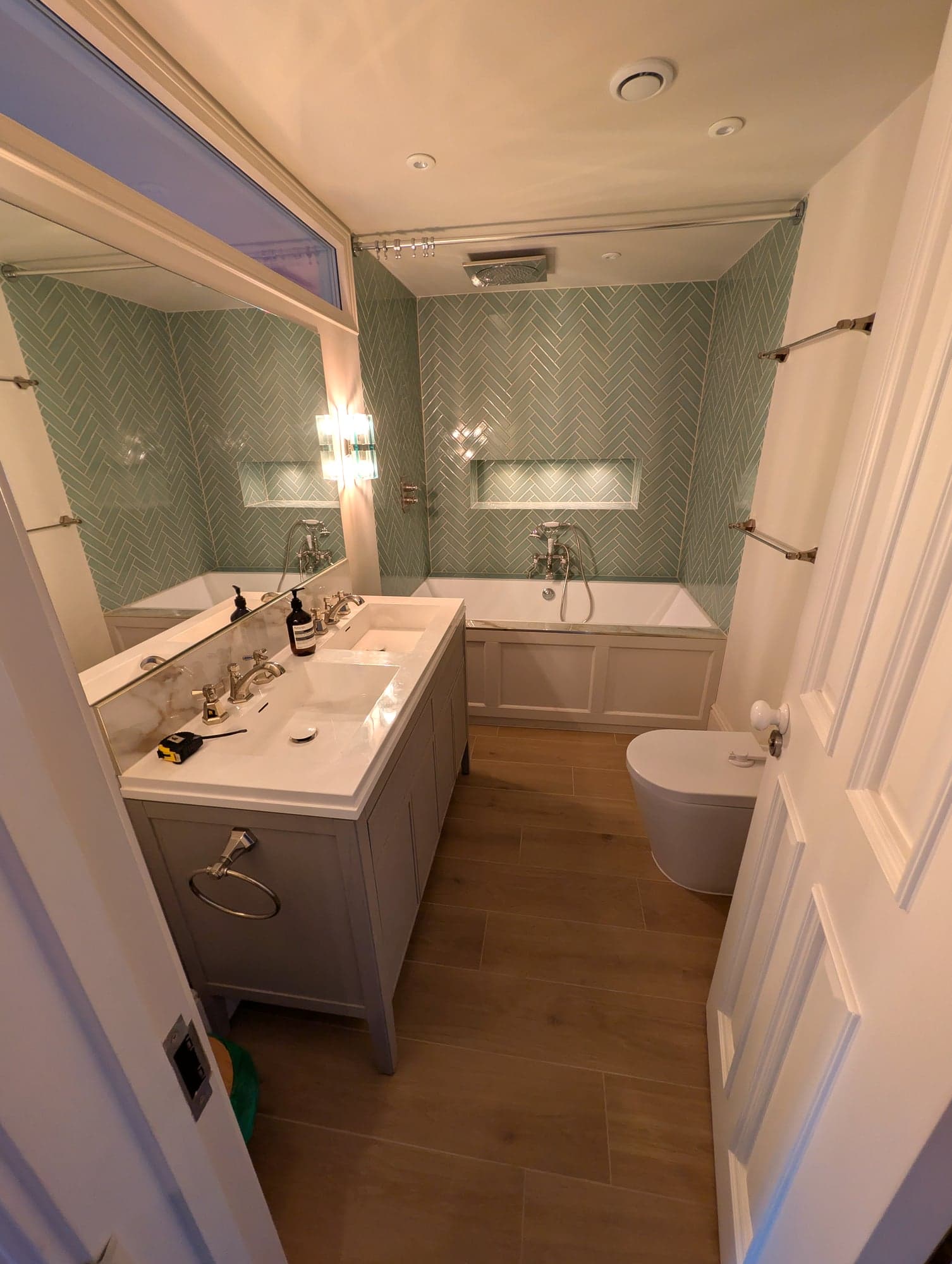 Close view of the vanity and nickel taps with the WC and oak floor behind, Fulham SW6