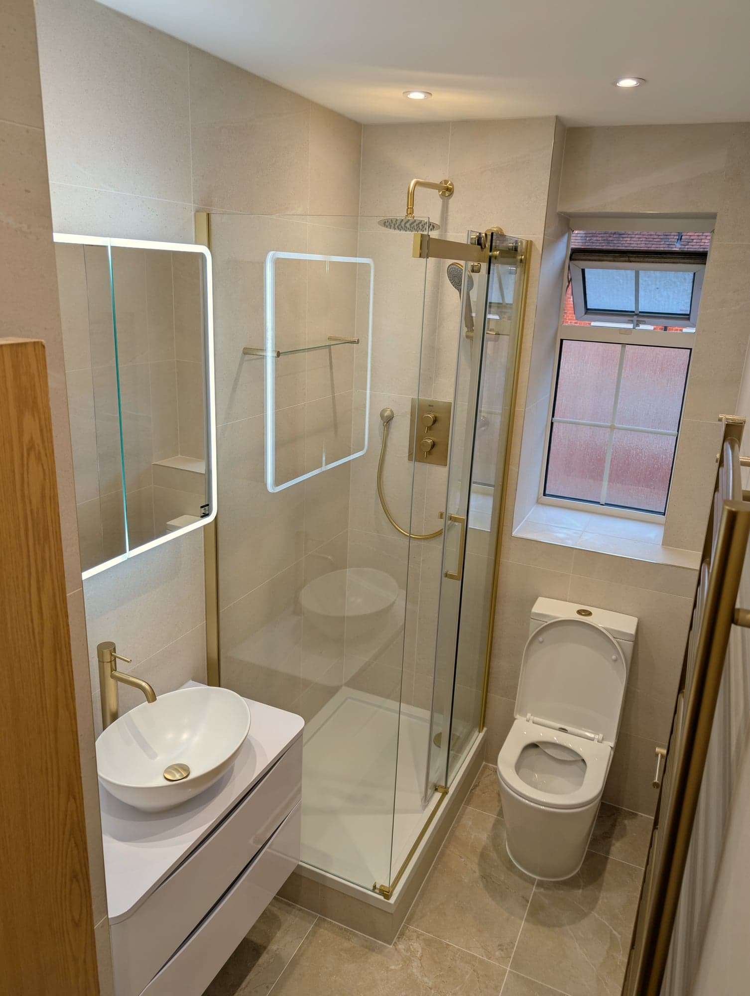 Shower enclosure and wall-hung WC with brass towel rail, Nine Elms SW8