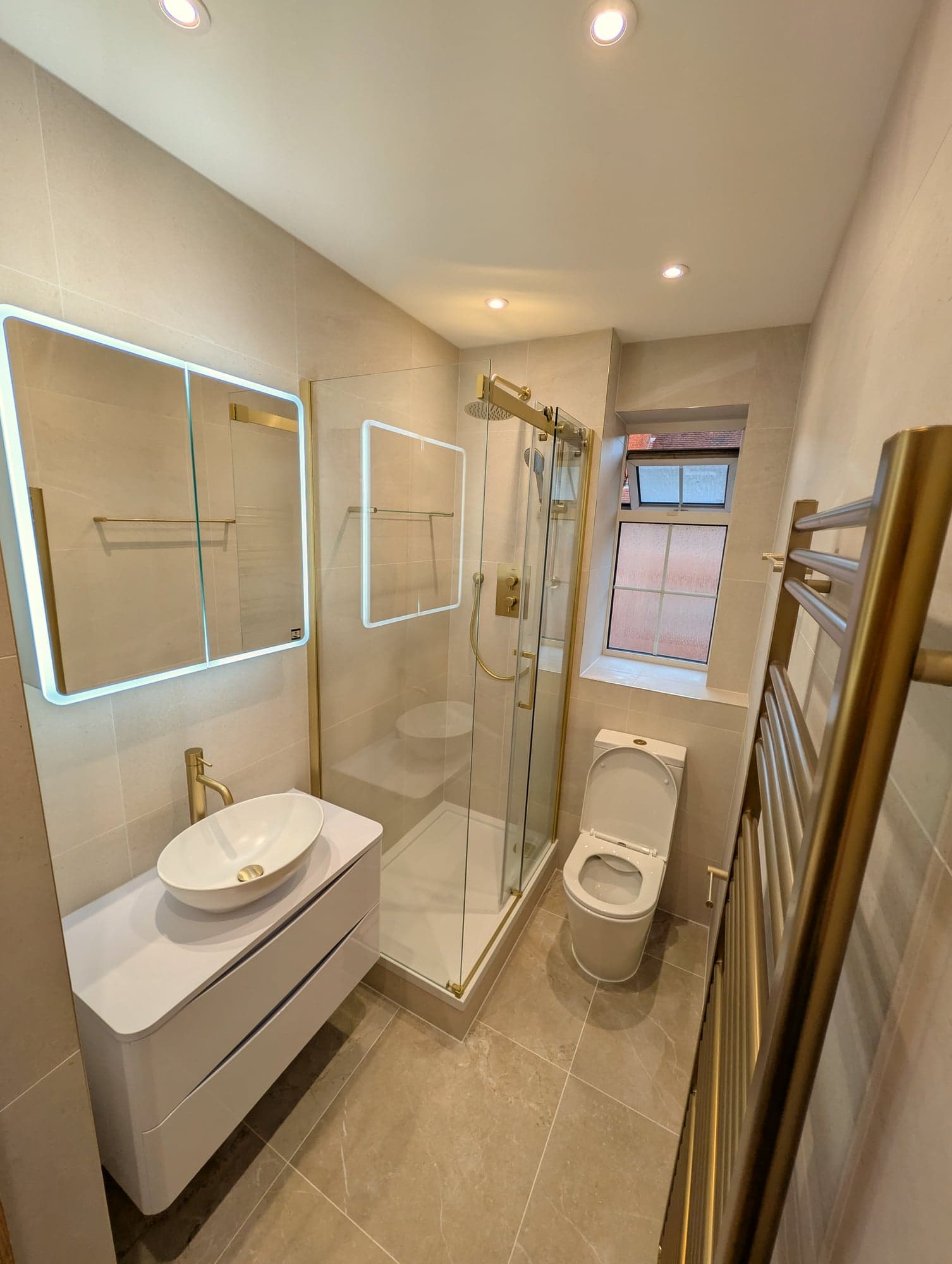 Backlit mirror above the countertop basin with the shower screen alongside, Nine Elms SW8