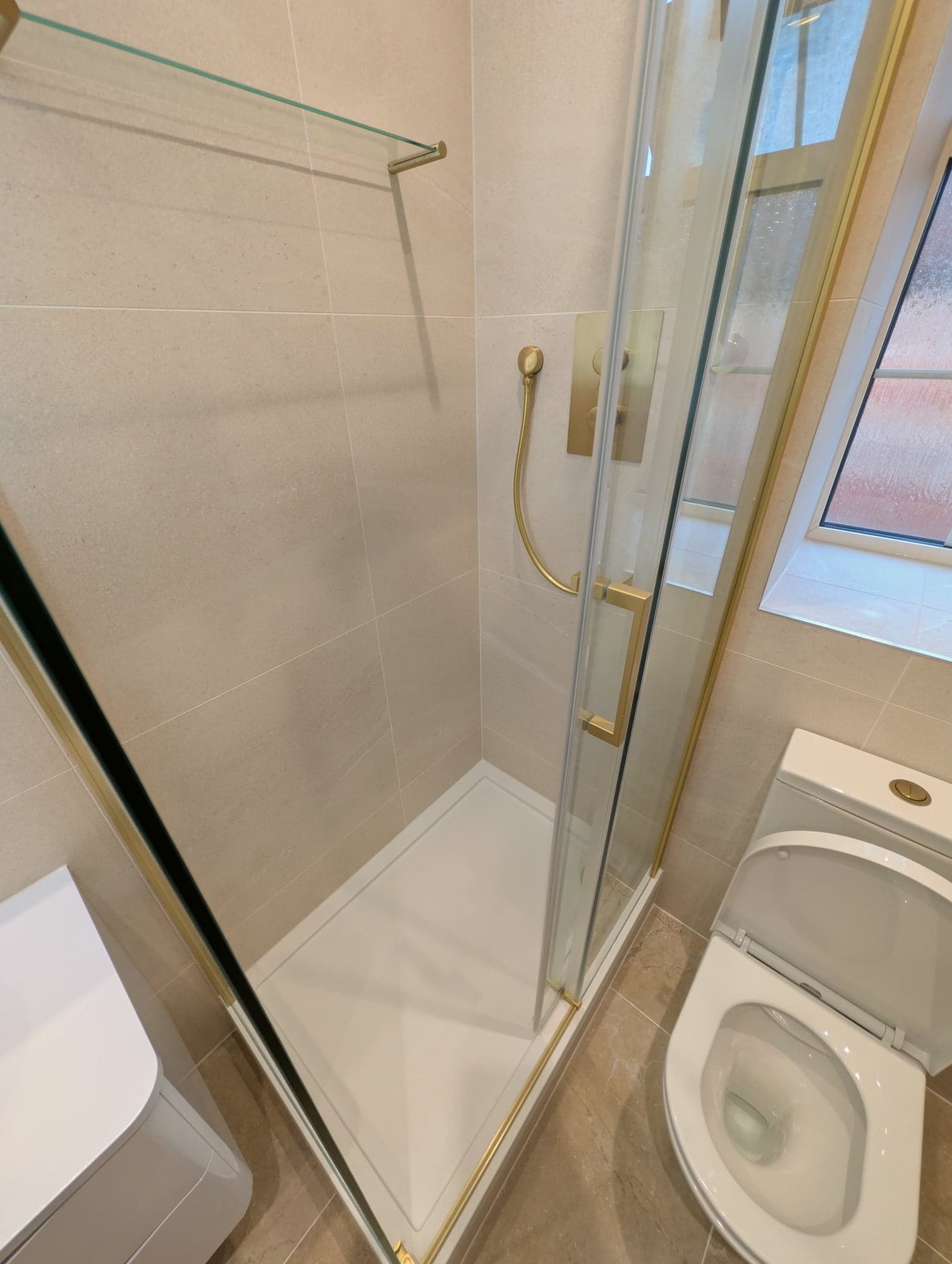 Shower tray and brass handset with the WC alongside, Nine Elms SW8