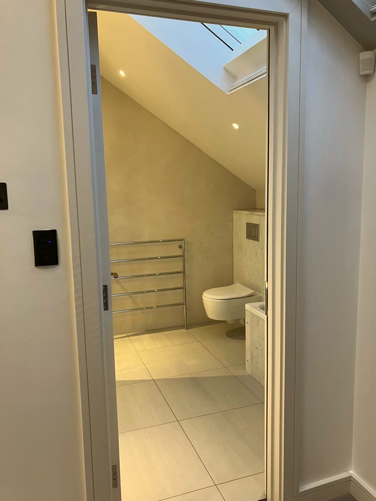 Bathroom seen from the landing with the rooflight above and heated towel rail beyond, South Kensington SW7