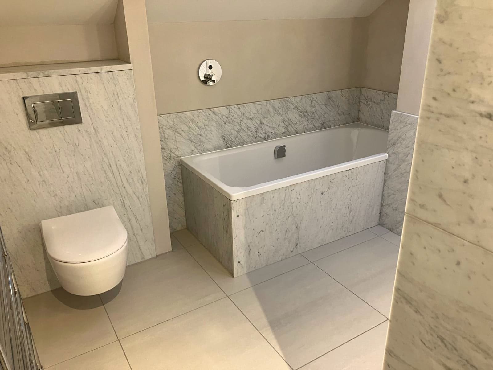 Marble-panelled bath with wall-hung WC alongside, South Kensington SW7