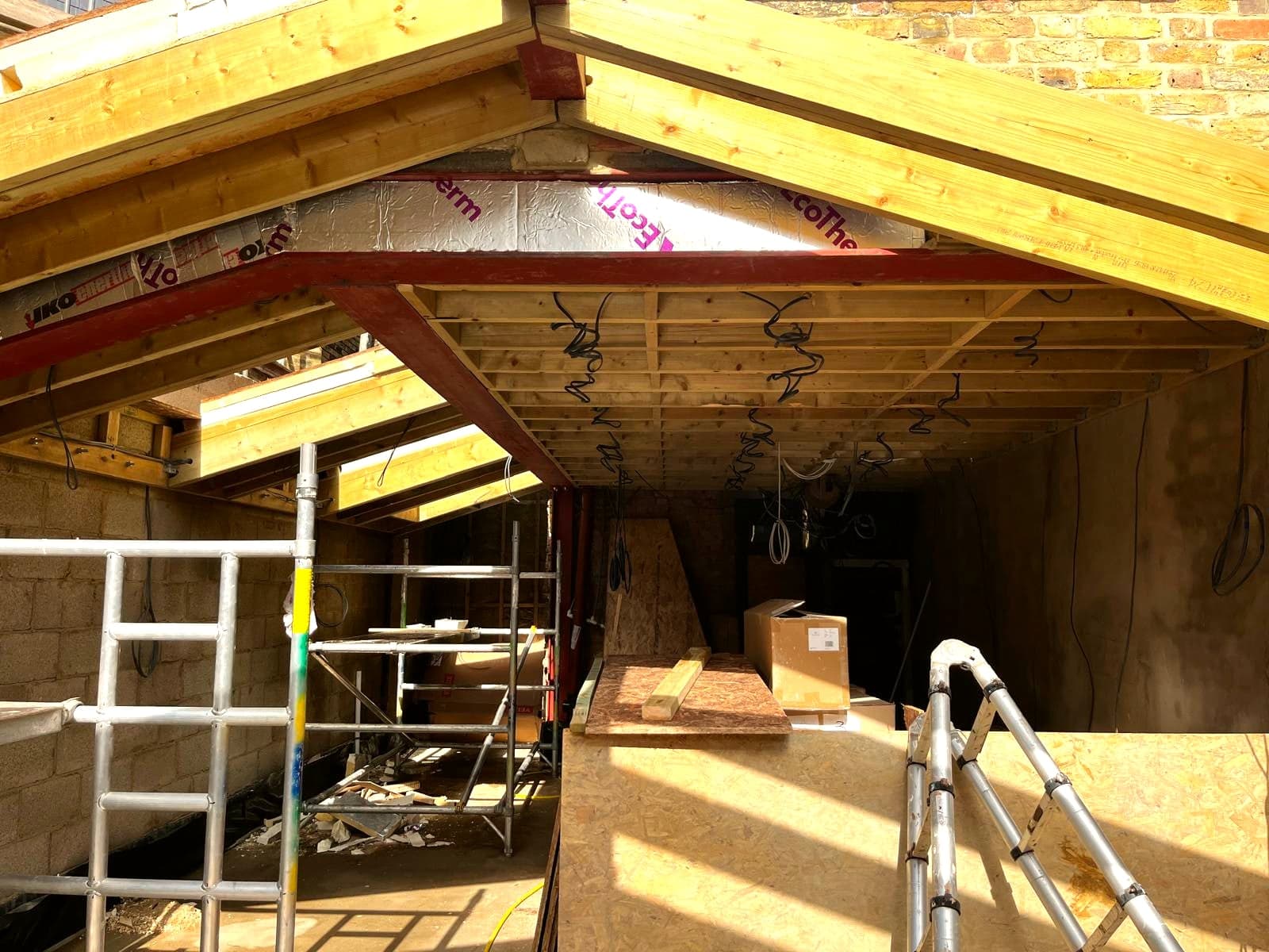 New timber roof structure and steel beam over the extension, scaffold inside, St Albans AL1