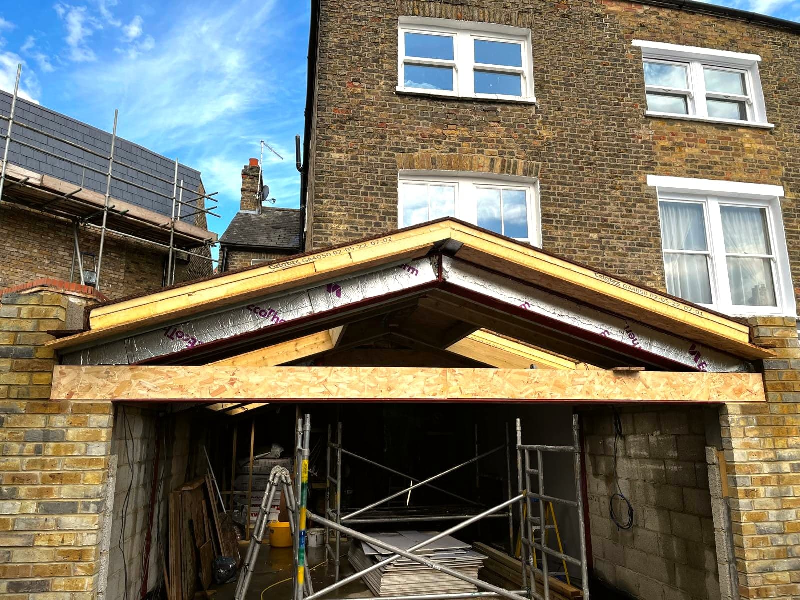 Rear elevation from the garden: new opening and timber roof structure under scaffold, St Albans AL1