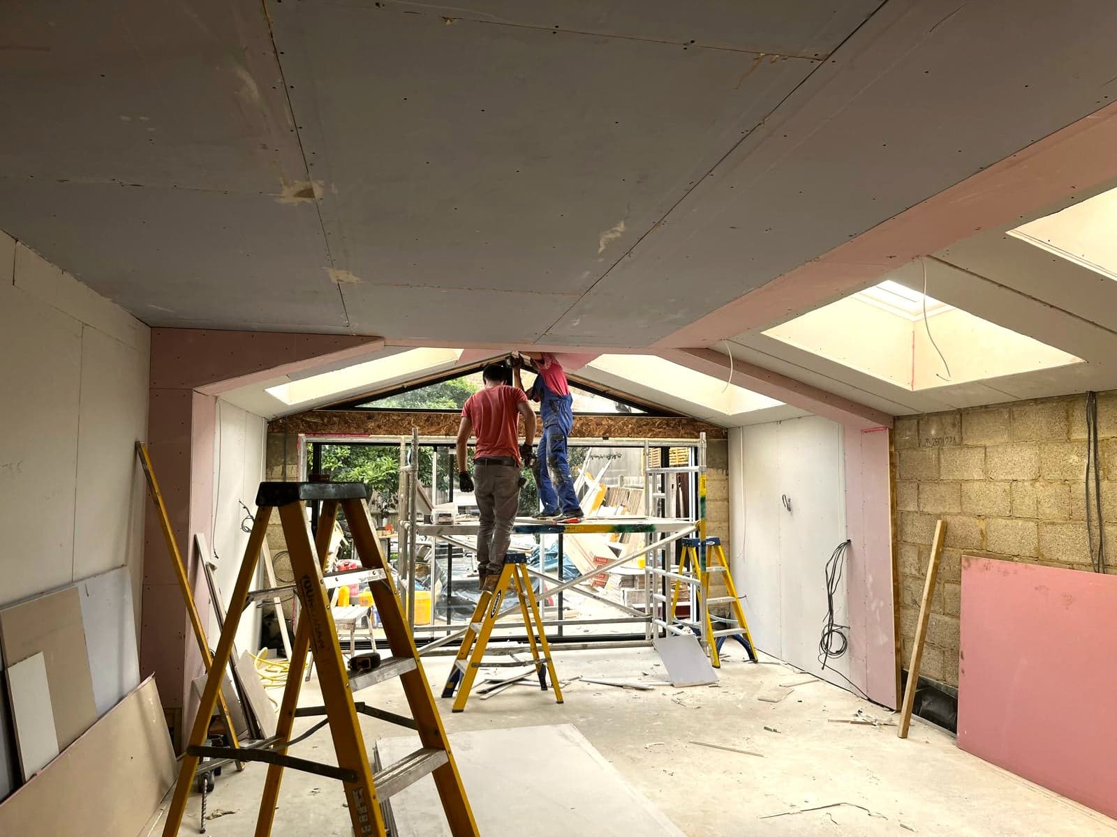 Plasterboarding under way with insulation boards stacked ready, St Albans AL1