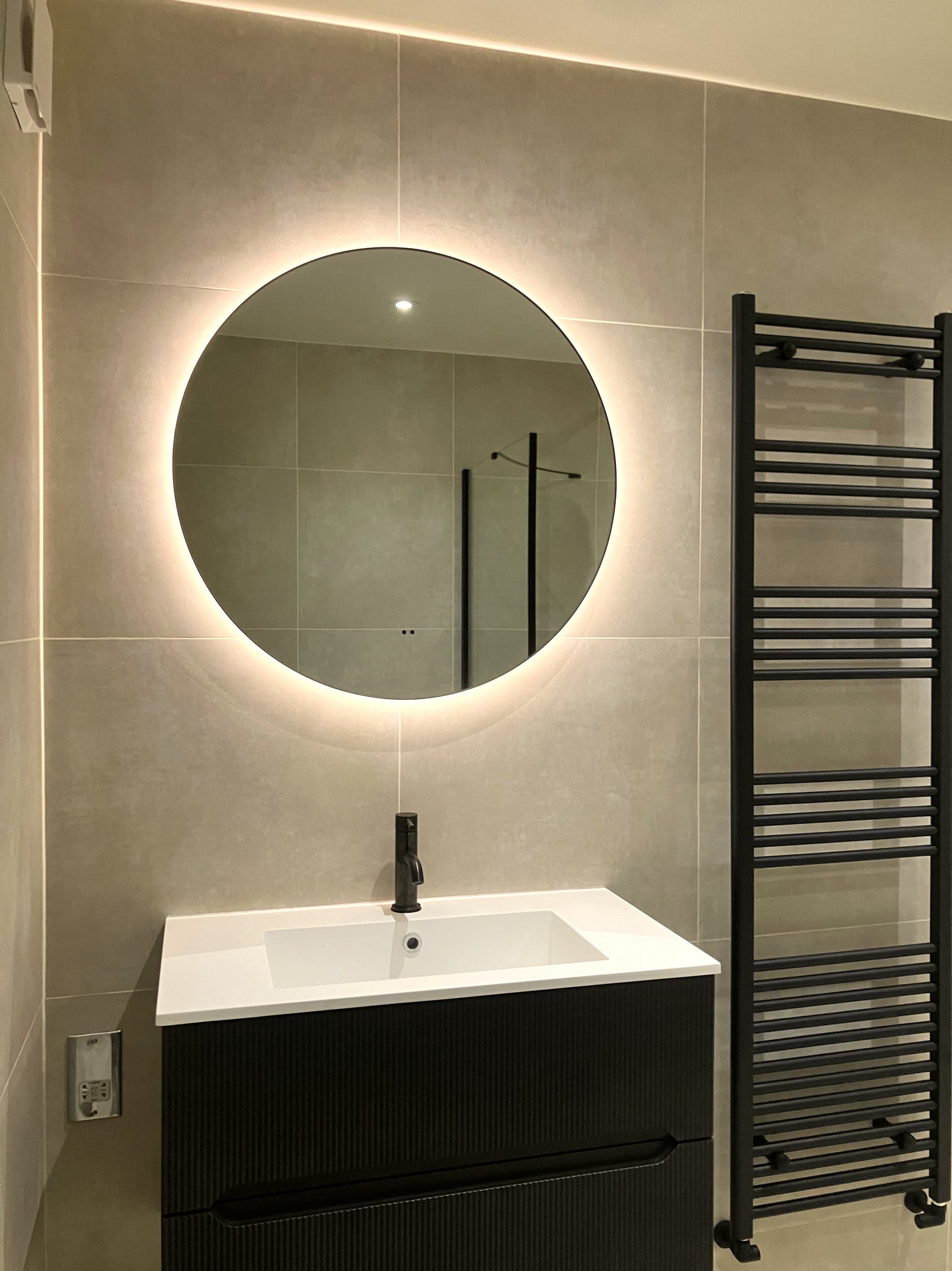 Vanity and mirror against large-format stone-effect tiling, Clapham Common SW4