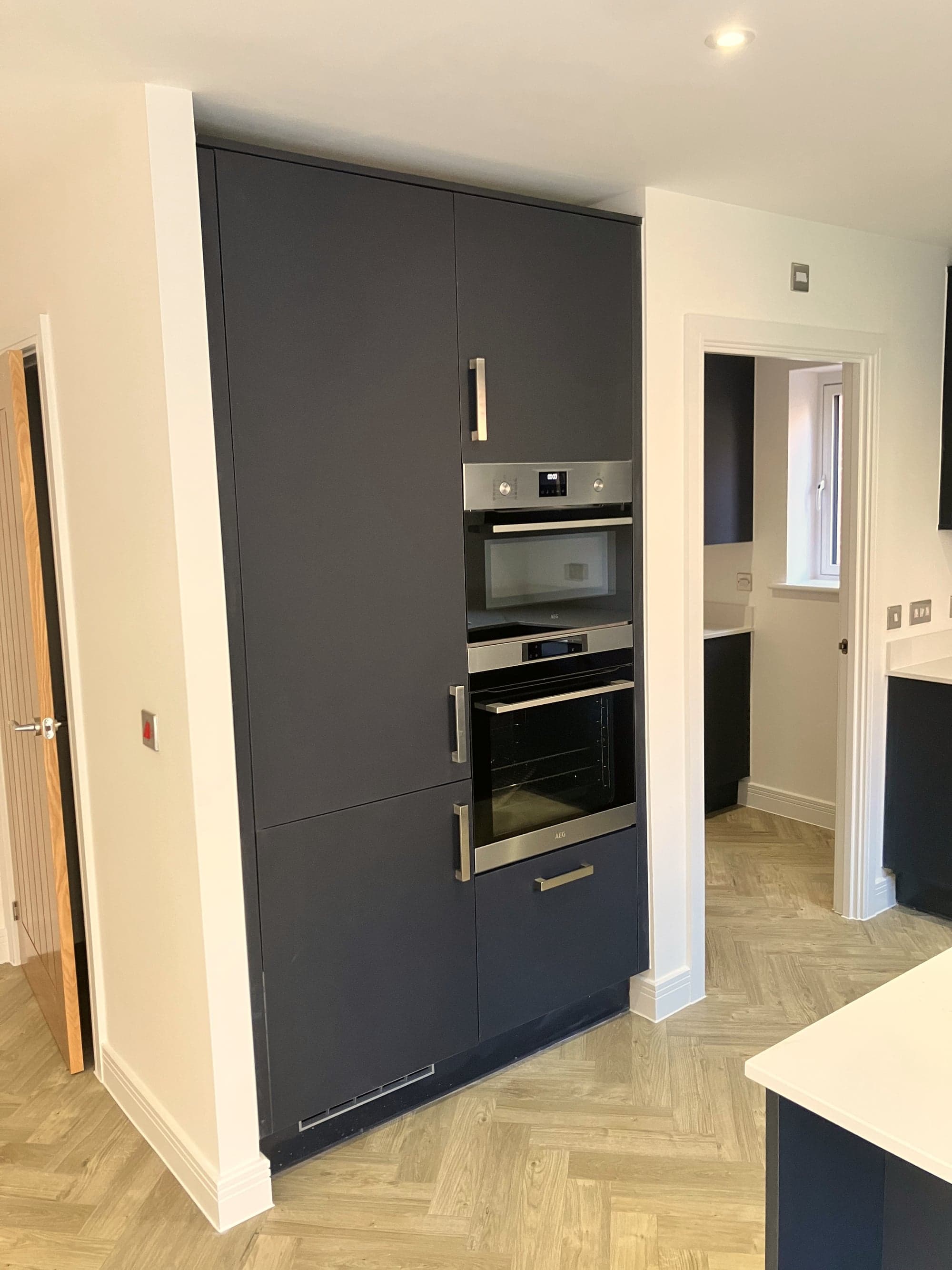 Full-height navy units housing the built-in double oven, Hampstead NW3