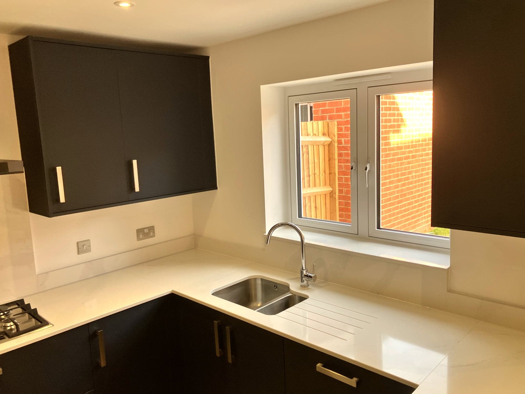 Inset sink under the window with the quartz worktop wrapping the corner, Hampstead NW3