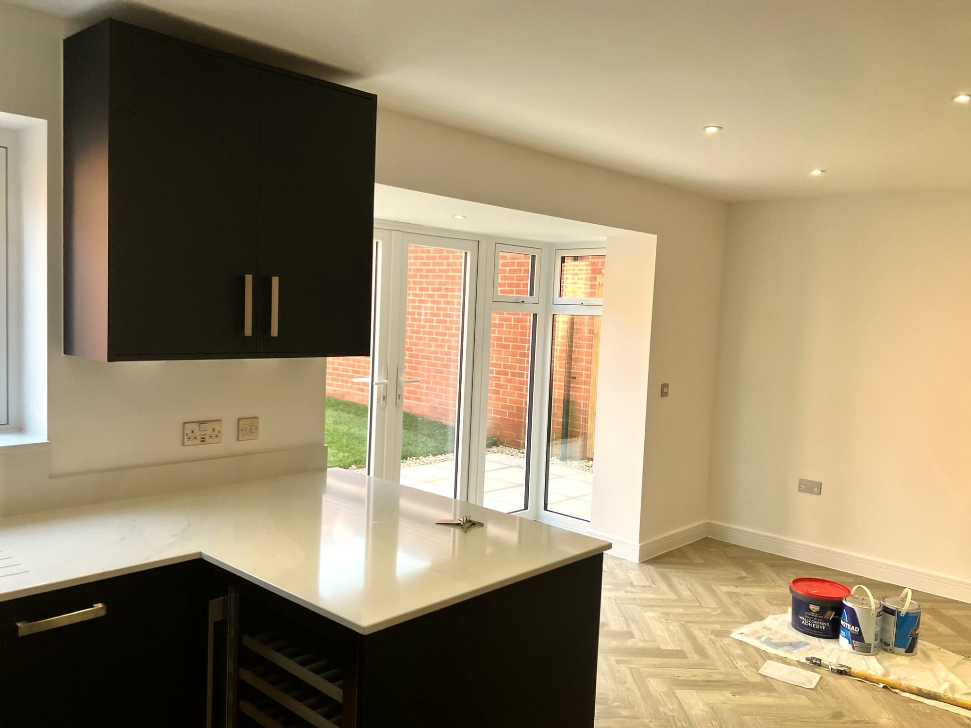 Quartz peninsula and worktop return with the garden doors beyond, Hampstead NW3