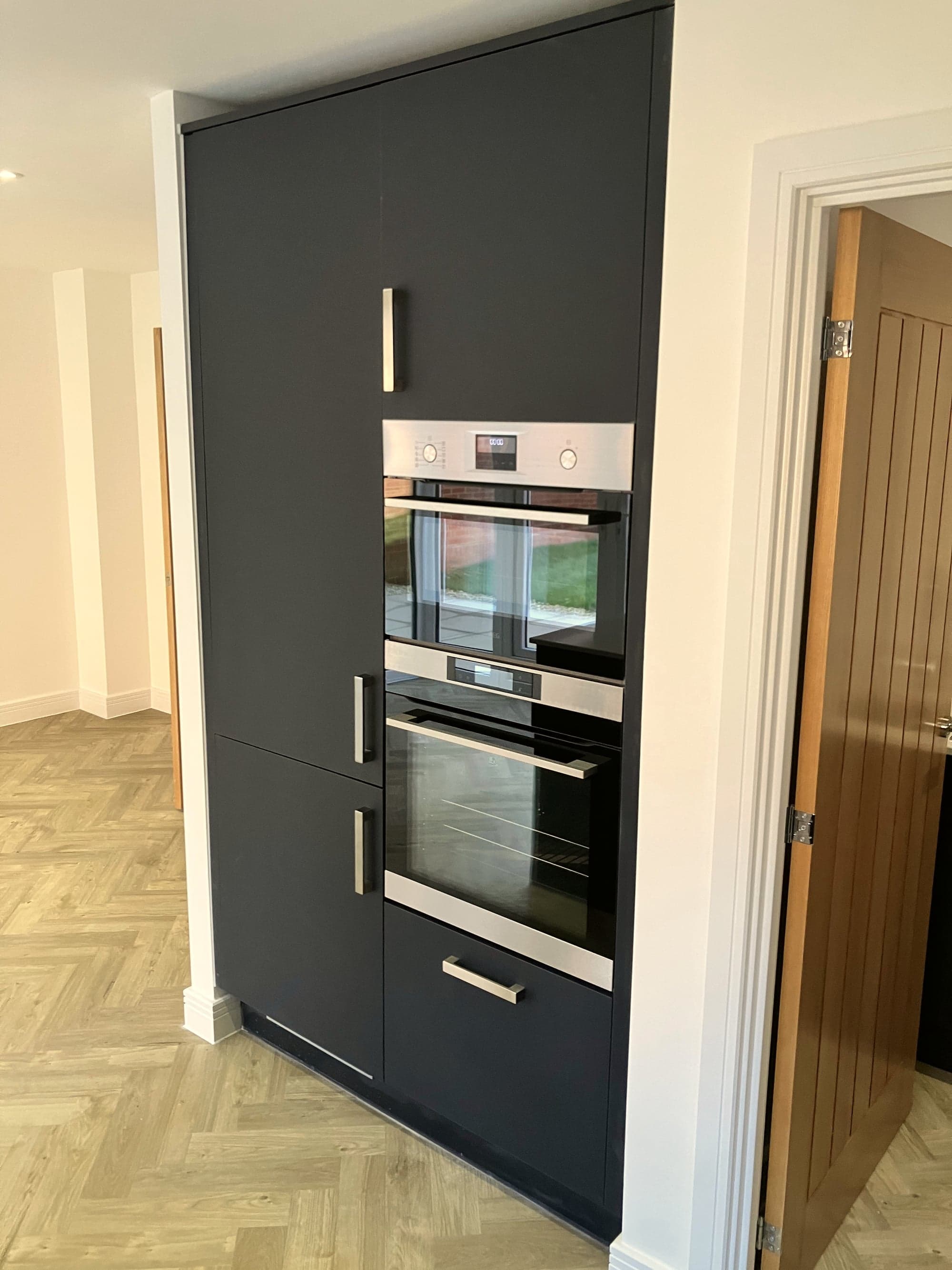 Built-in double oven in the navy tall unit beside the hall door, Hampstead NW3