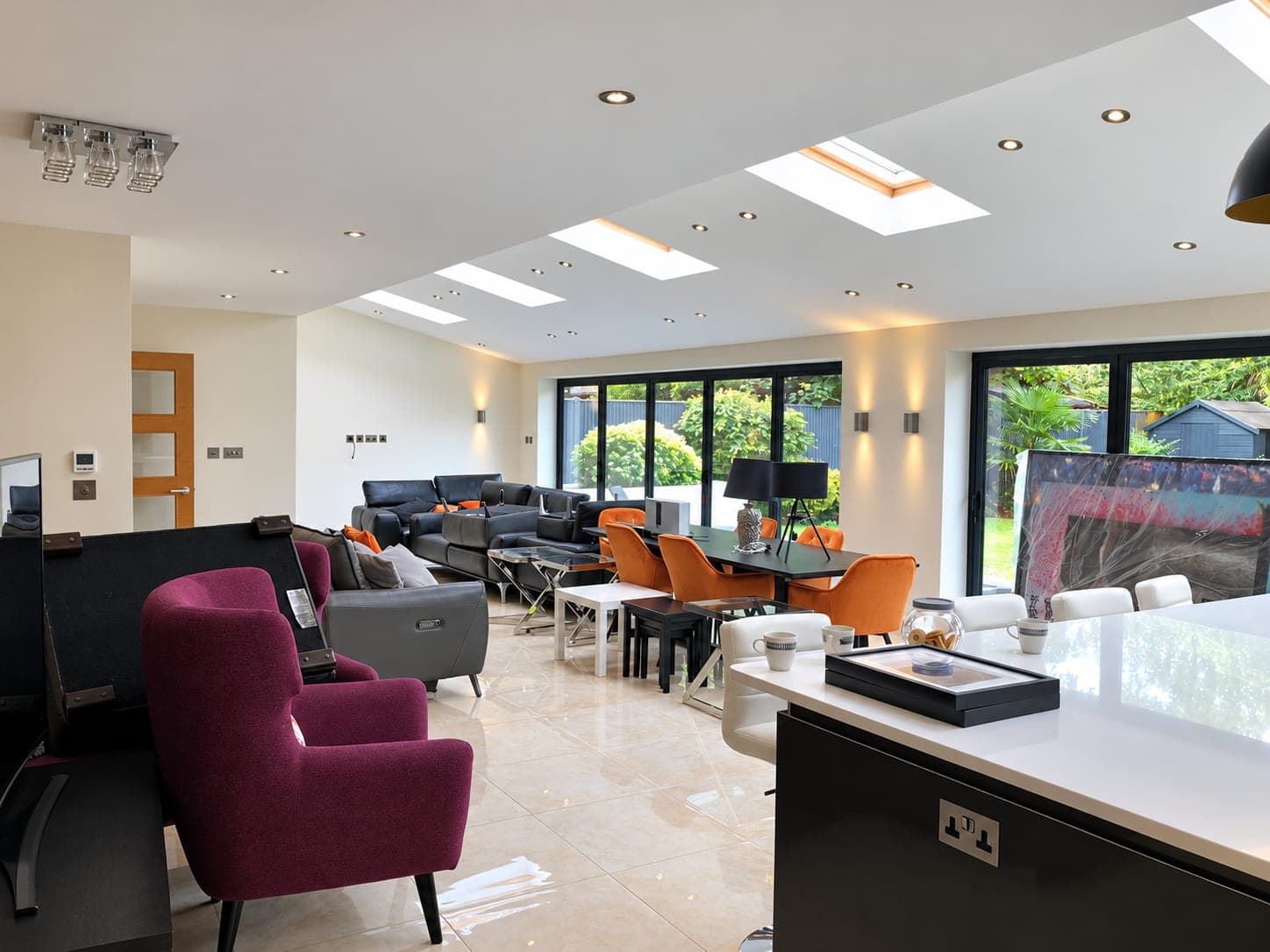 Open-plan space from the kitchen end, rooflights and bi-folds beyond, Richmond TW9