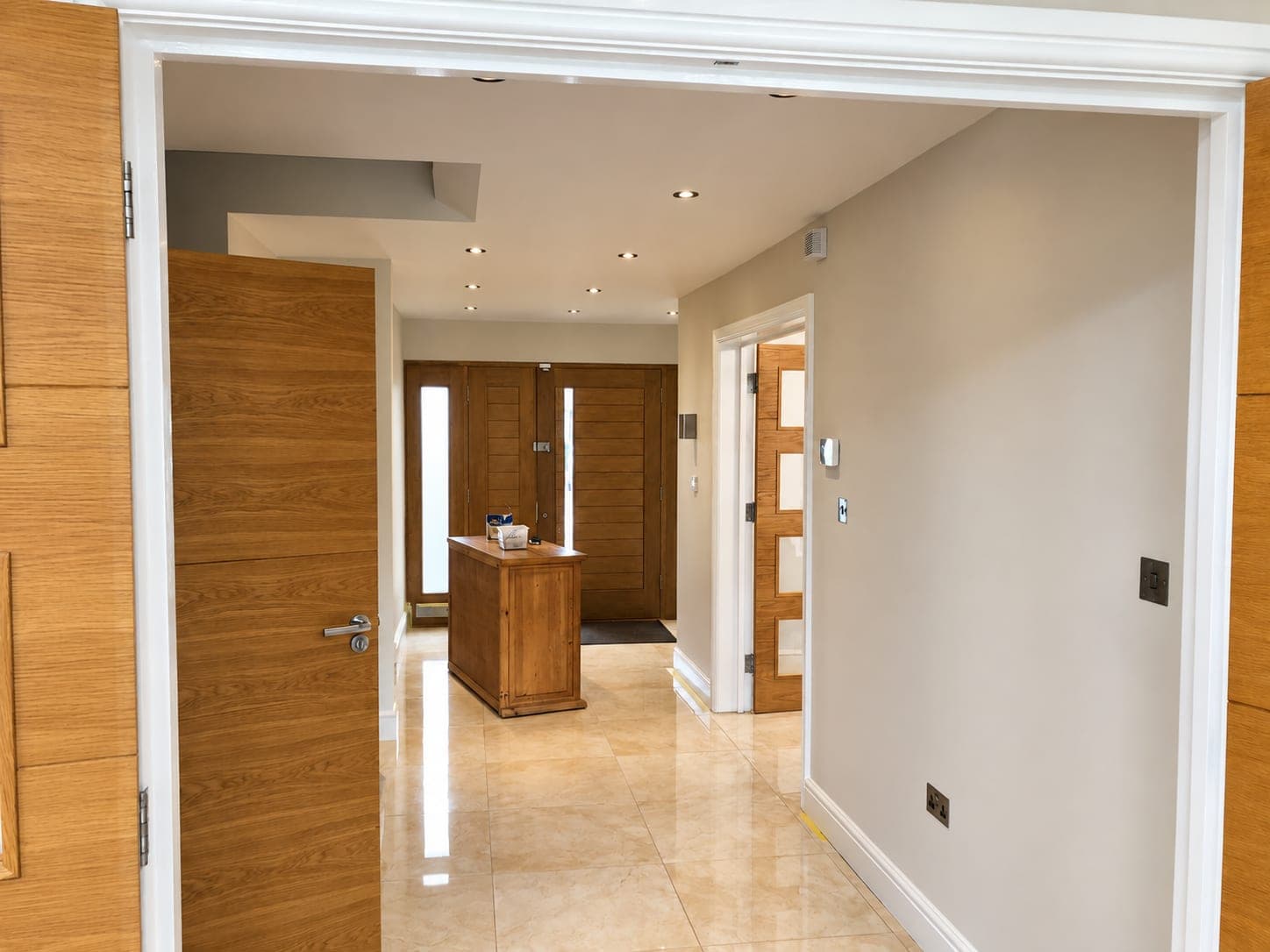 Oak doors and frames left clean against freshly painted white walls, Richmond TW9