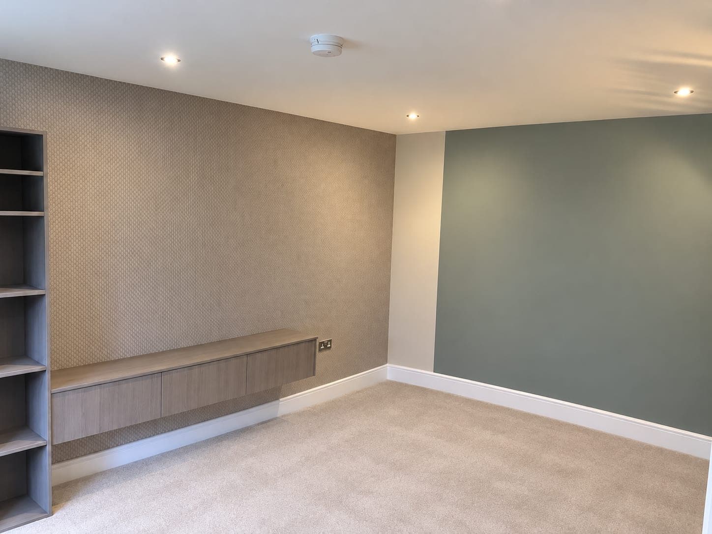 Textured wallcovering and sage feature wall in a living room, London