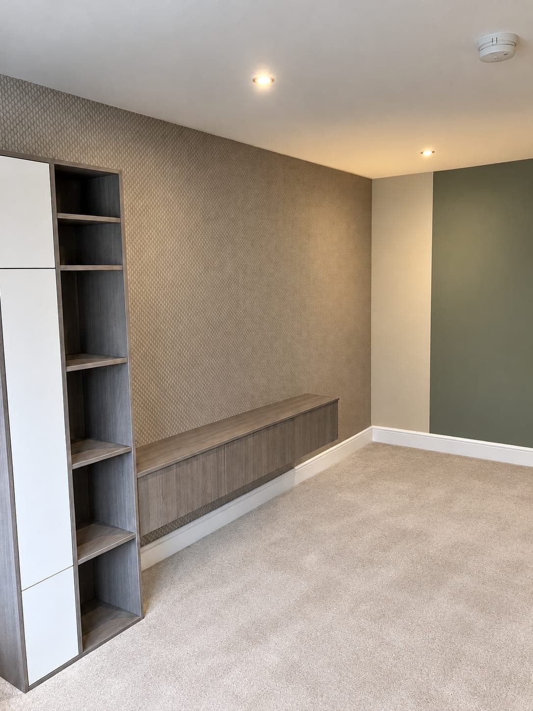 Fitted shelving and bench against the papered wall, London Colney AL2