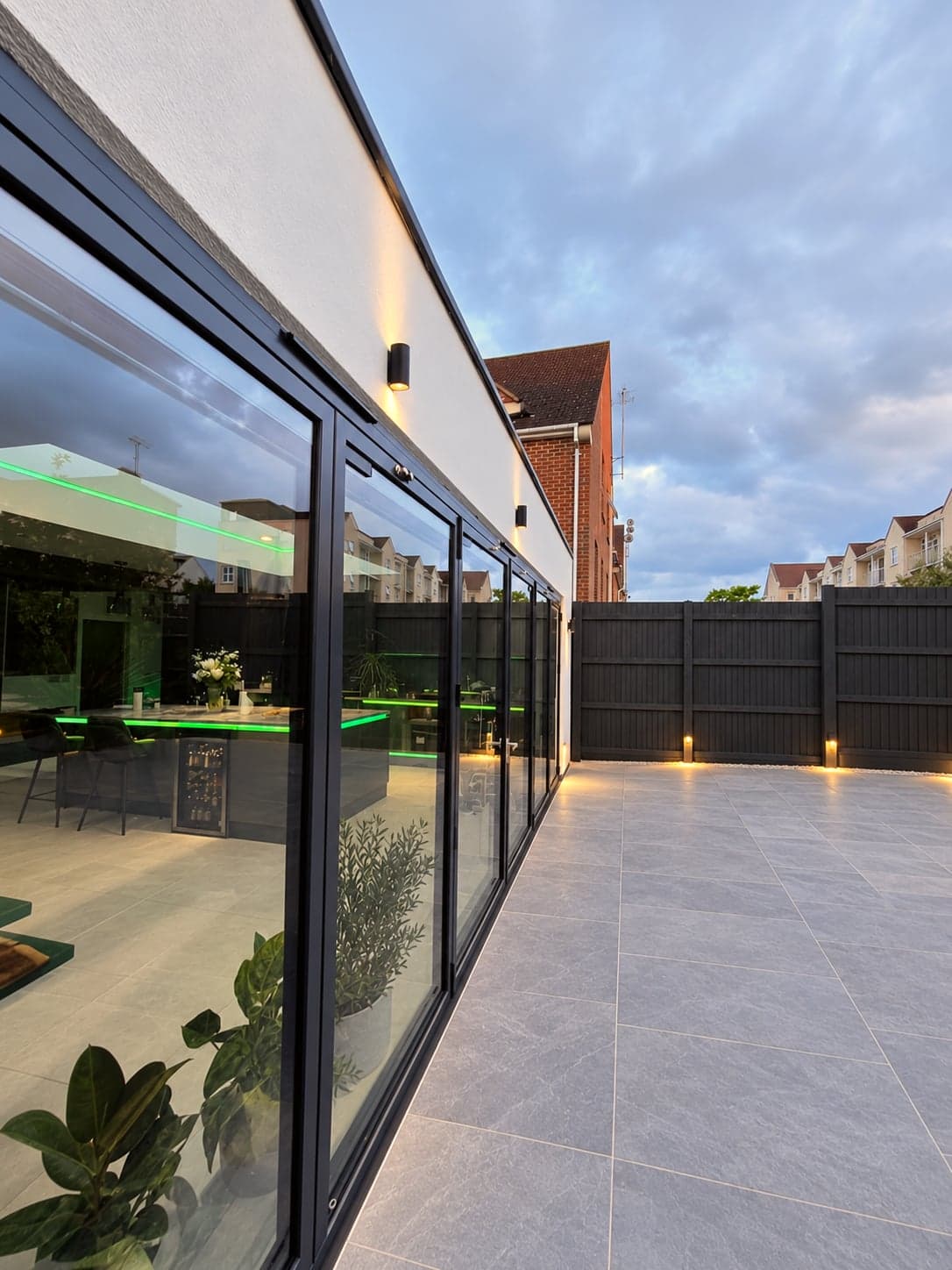 Evening view across the patio to the fully glazed rear extension, High Barnet EN5