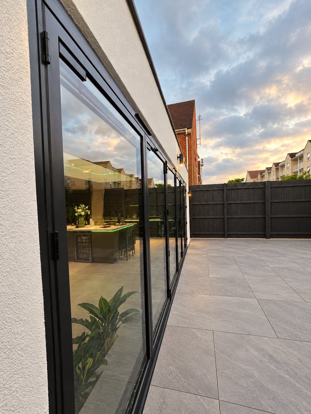Sliding doors reflecting the evening sky along the extension elevation, High Barnet EN5