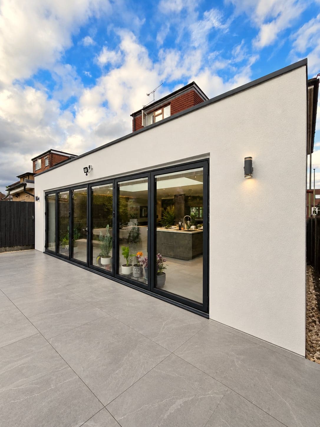 Finished rear extension with full-width bi-fold doors and white render finish, High Barnet EN5