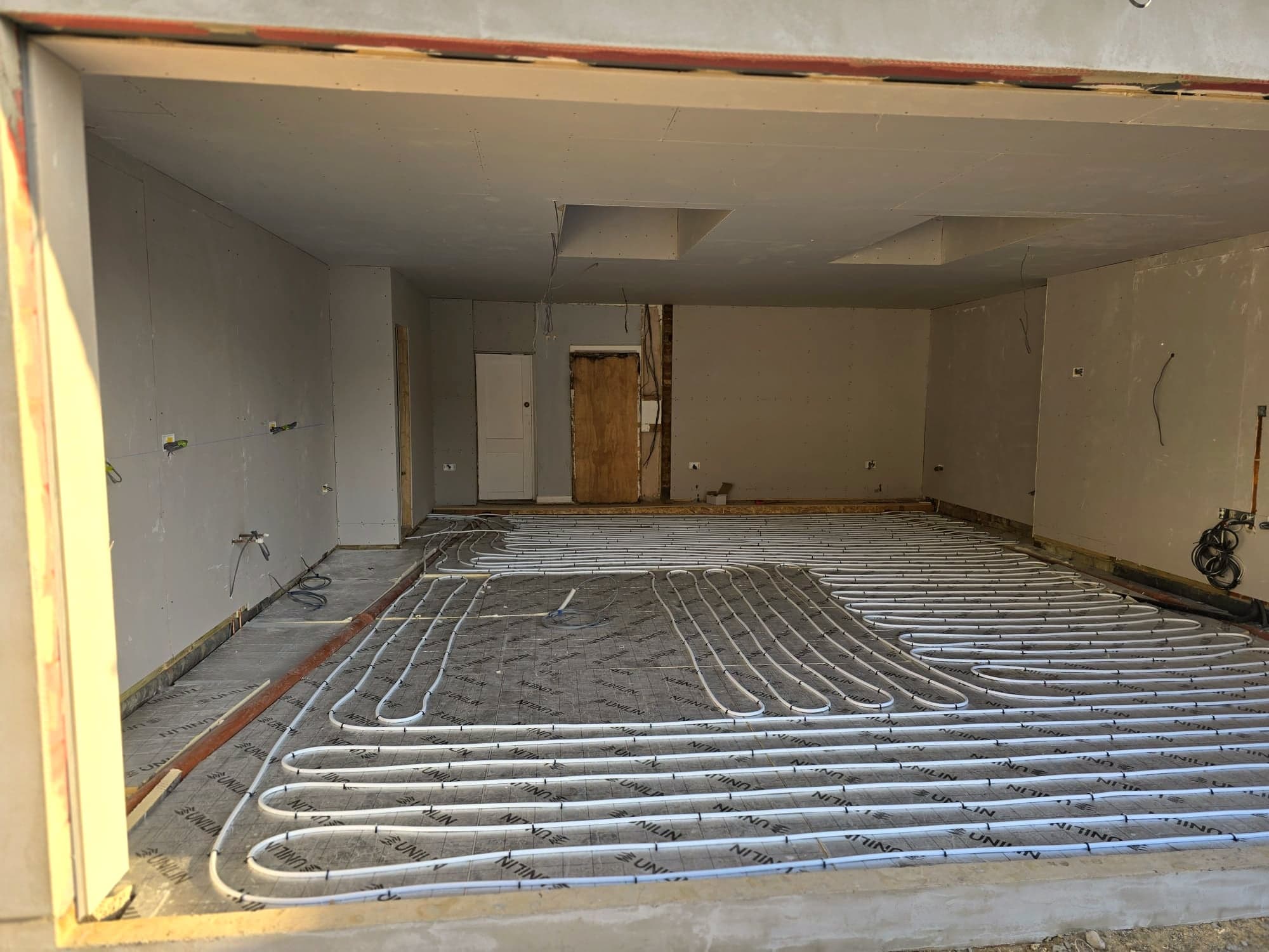 Underfloor heating pipework laid across the new slab before screeding, High Barnet EN5