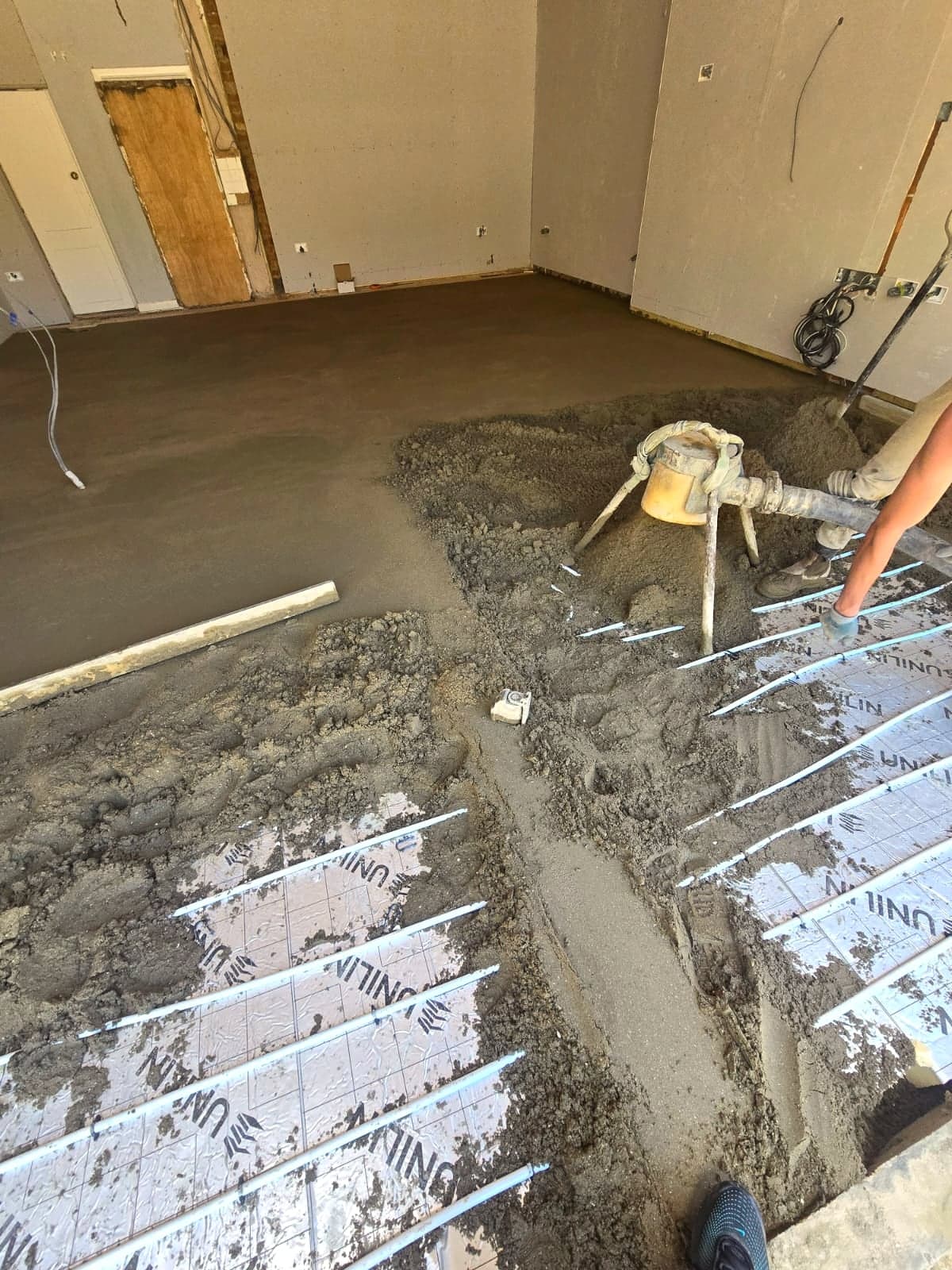 Screed being laid over the underfloor heating and insulation boards, High Barnet EN5