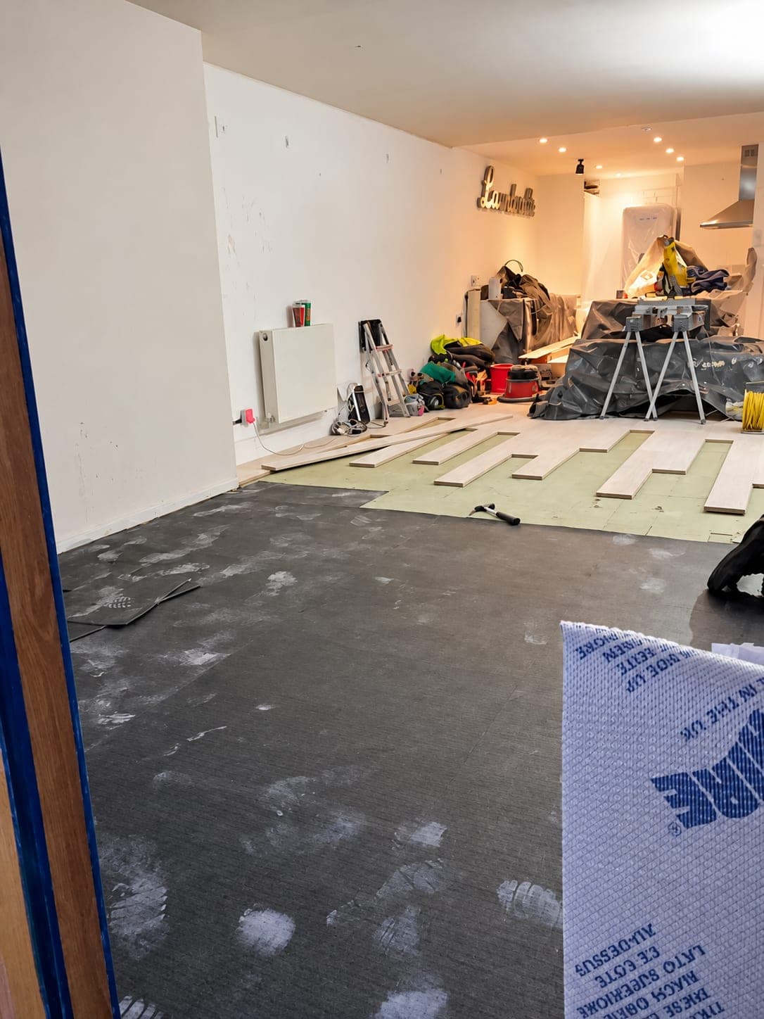 Flooring being laid over the insulation boards, Stanmore HA7