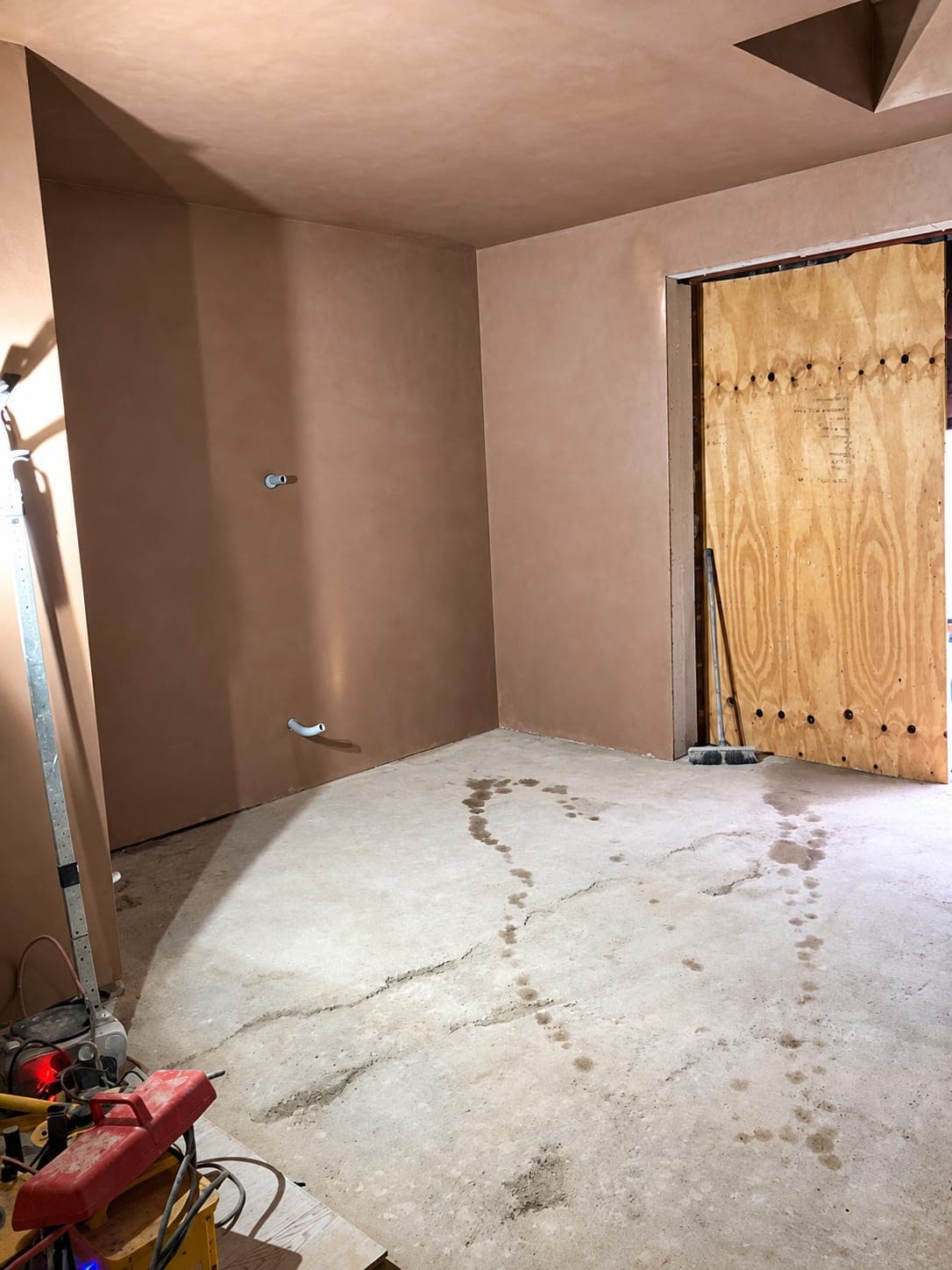 Freshly plastered walls and ceiling with the opening boarded up, Stanmore HA7
