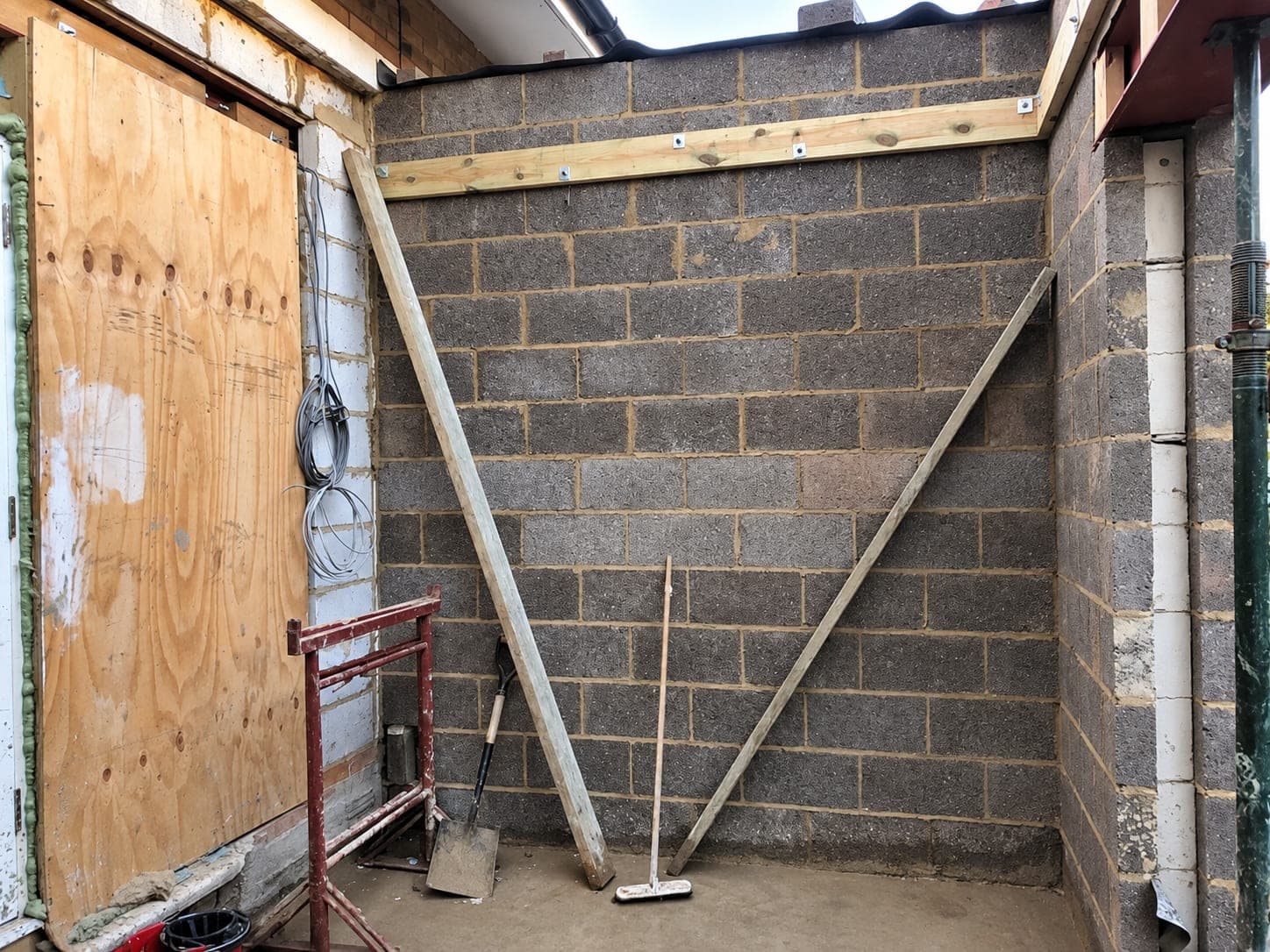 Blockwork walls up with the opening boarded over, Stanmore HA7