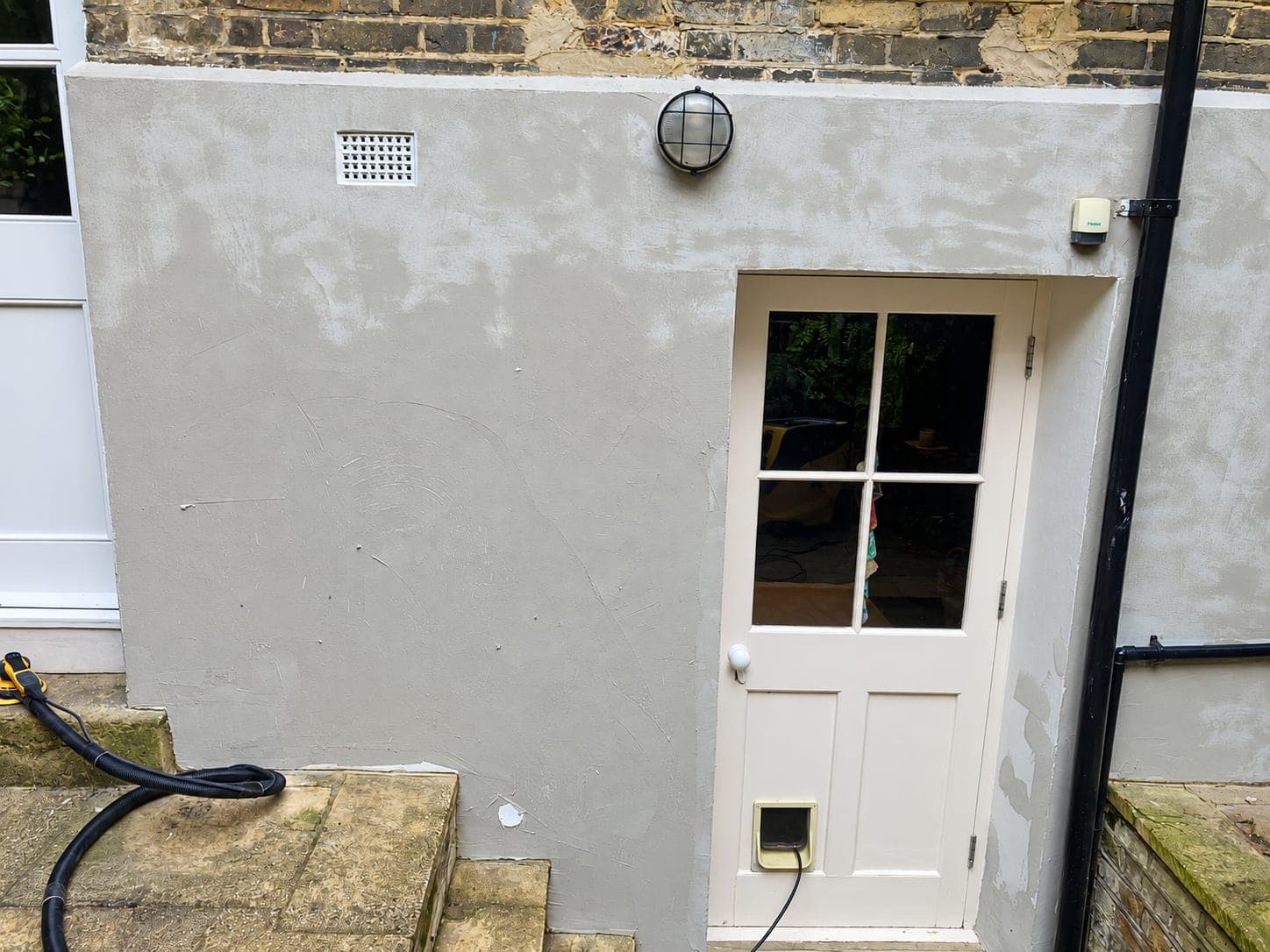 Base coat applied to the lightwell wall before the top coat, Hammersmith W6
