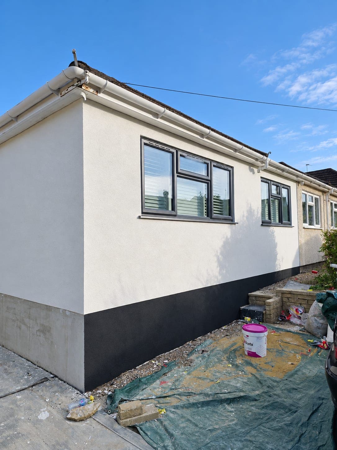 Completed render across the front elevation with the dark plinth below, Bricket Wood AL2