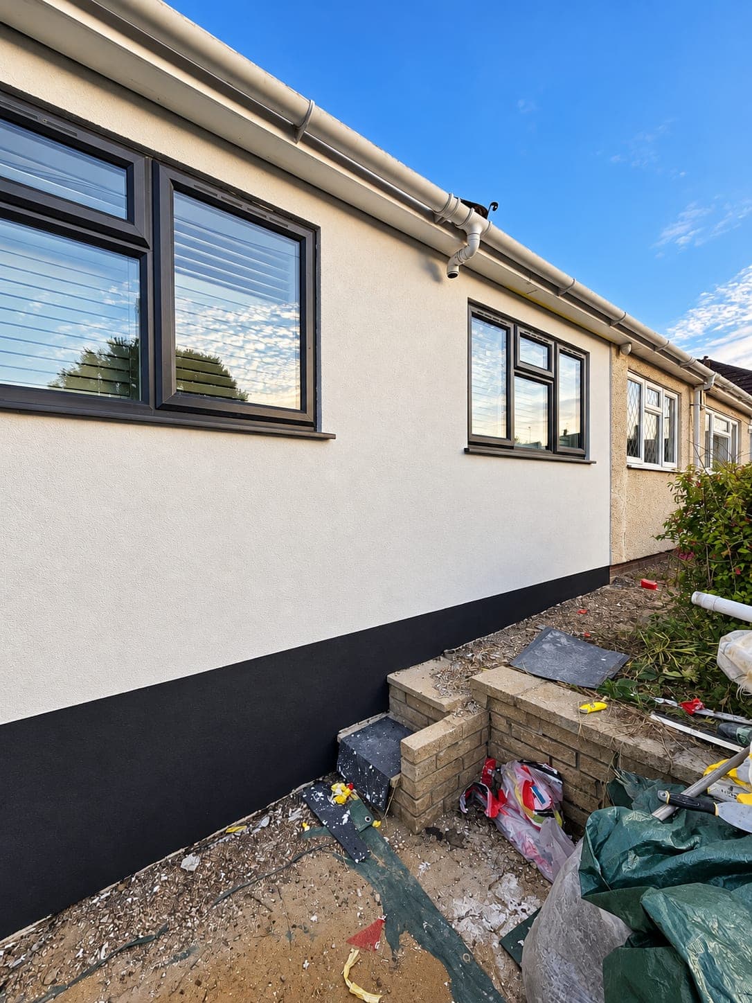Rendered elevation and plinth meeting the garden wall, Bricket Wood AL2