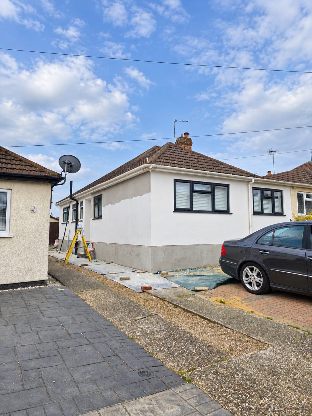 The front elevation finished in white silicone render, London