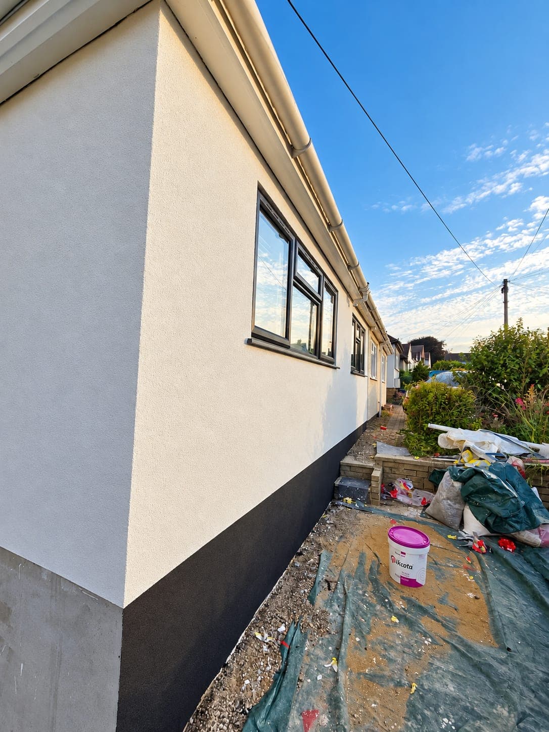 Finished white render against the clear sky, Bricket Wood AL2