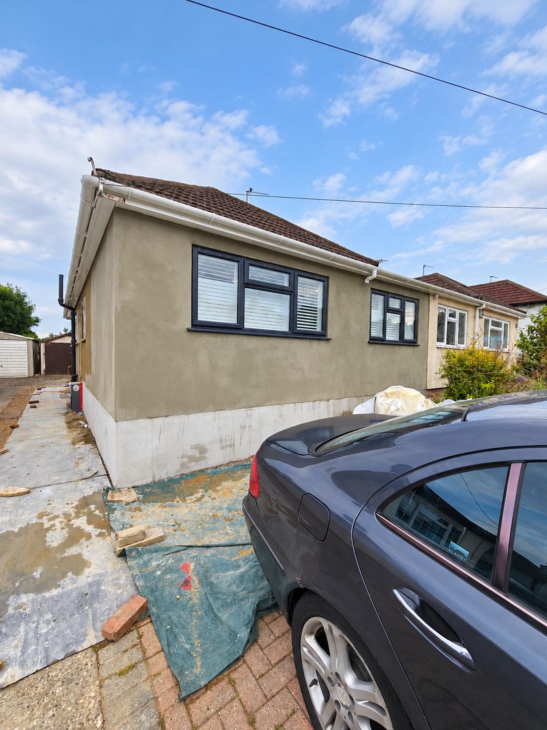Tired cream render on the front elevation before the works, London