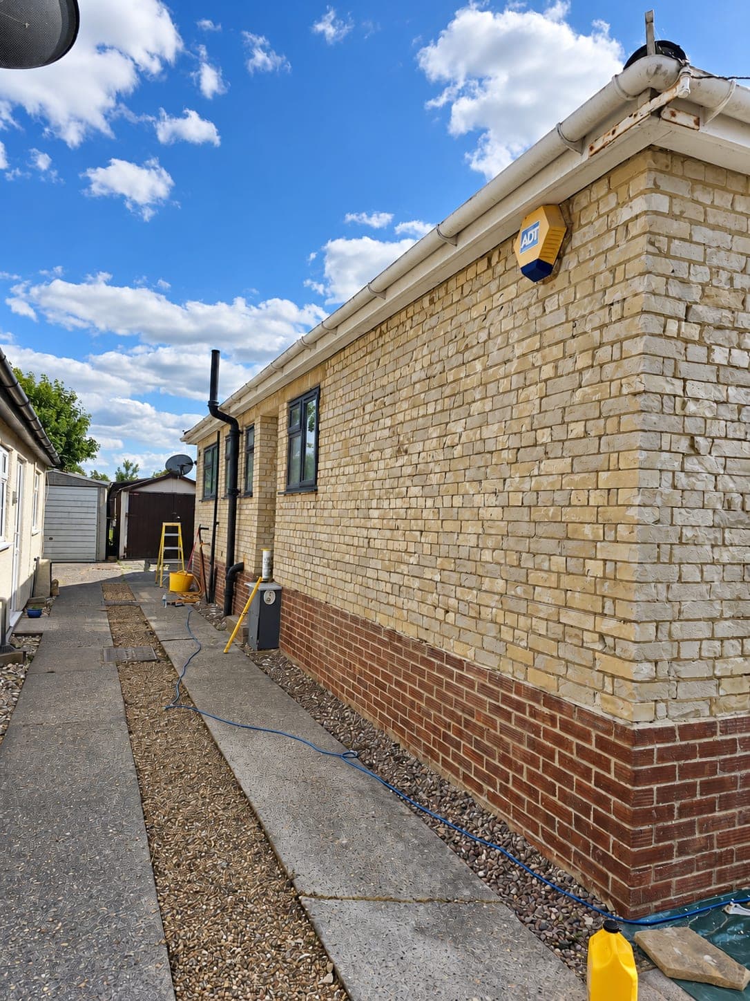 Brick elevation seen along the side path before rendering, London