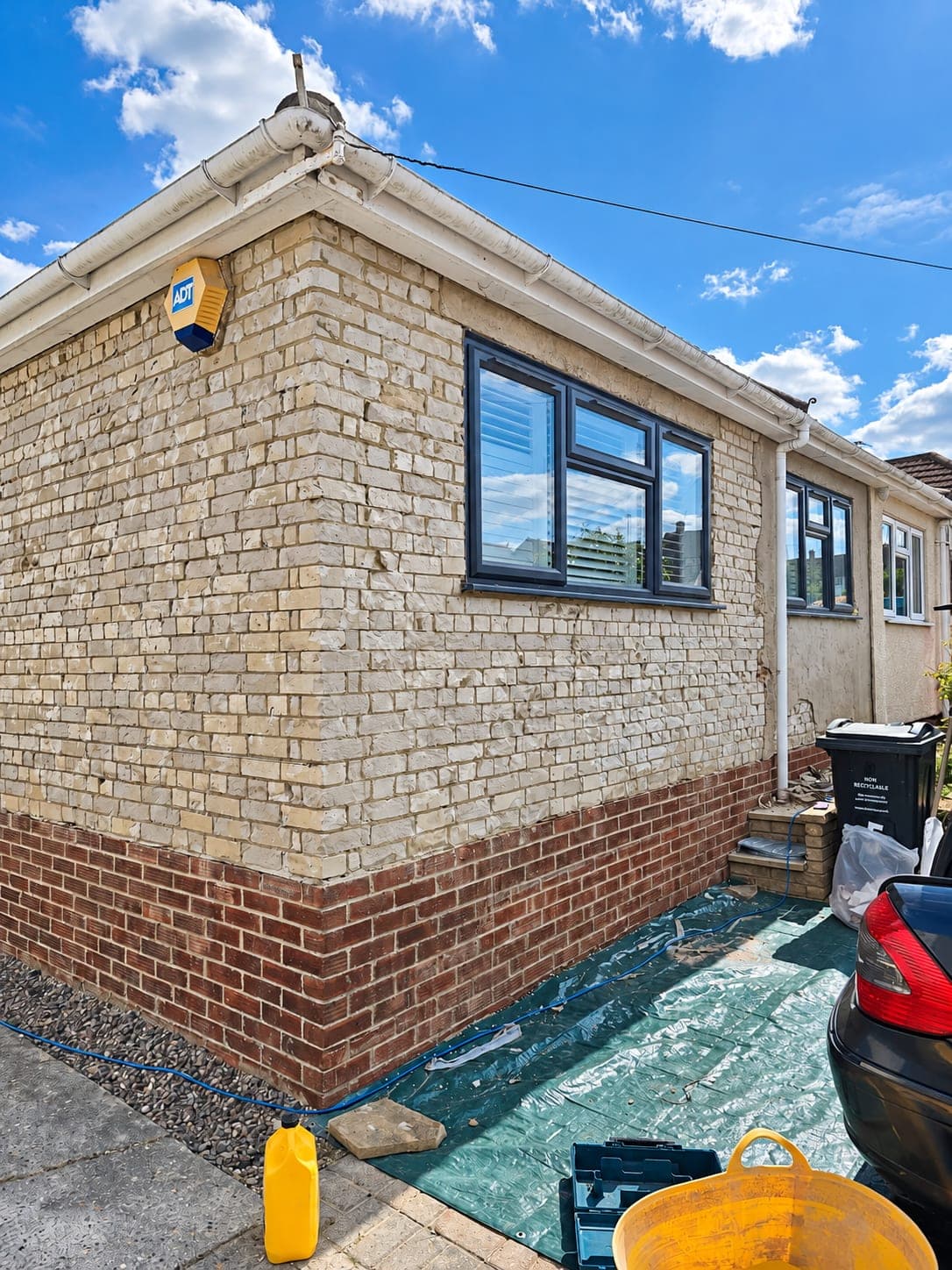 Yellow stock brick side elevation of a bungalow before rendering, London