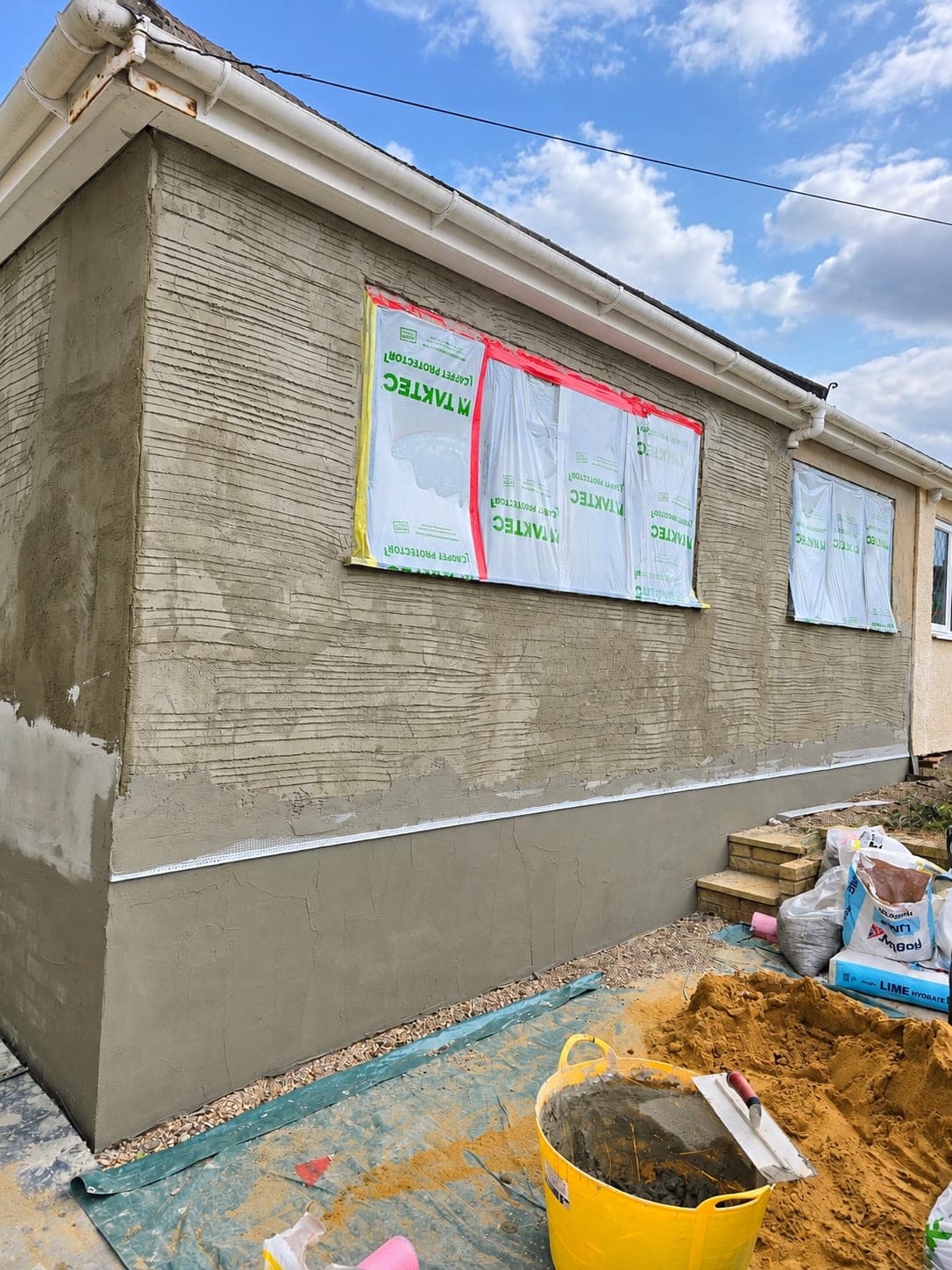 Base coat being worked across the rendered elevation, Bricket Wood AL2