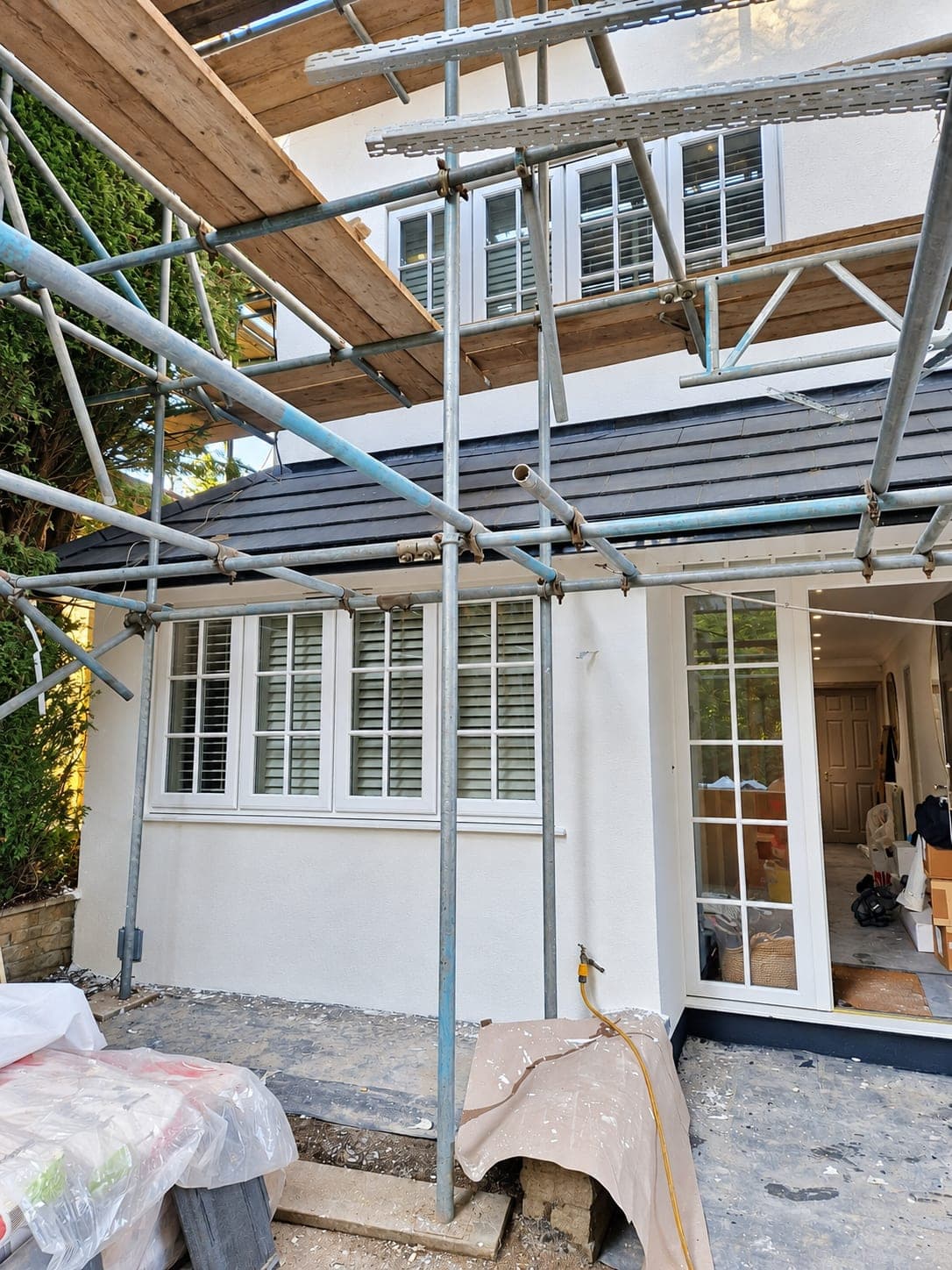 Rear elevation rendered and finished behind the scaffold, Enfield EN3