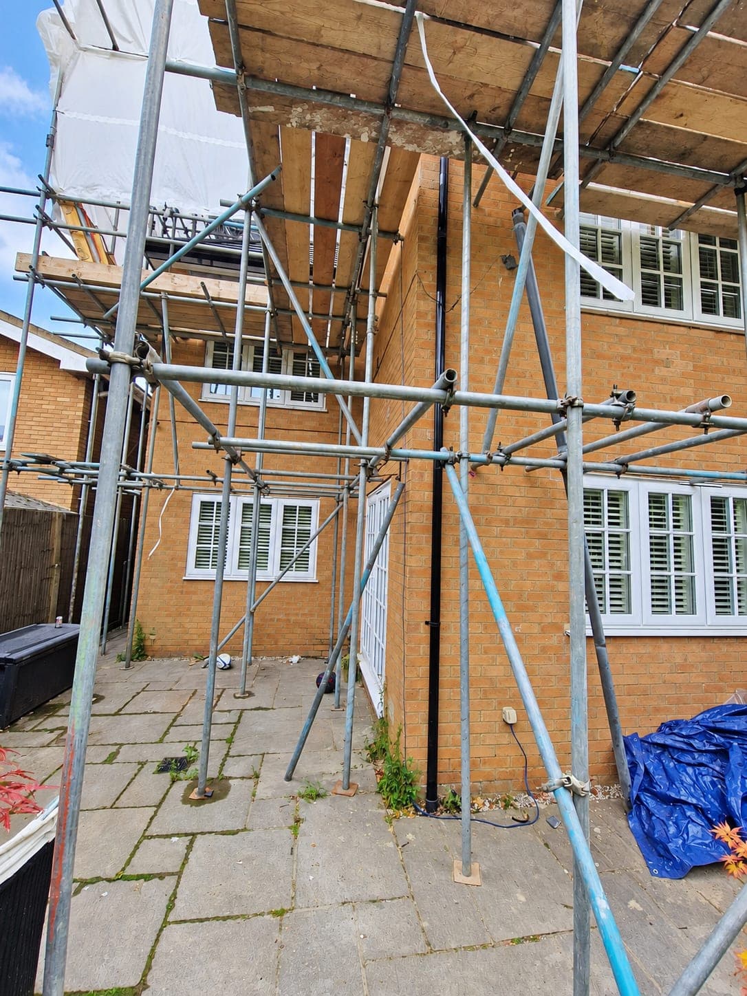 Red brick rear elevation of a detached house before rendering, London