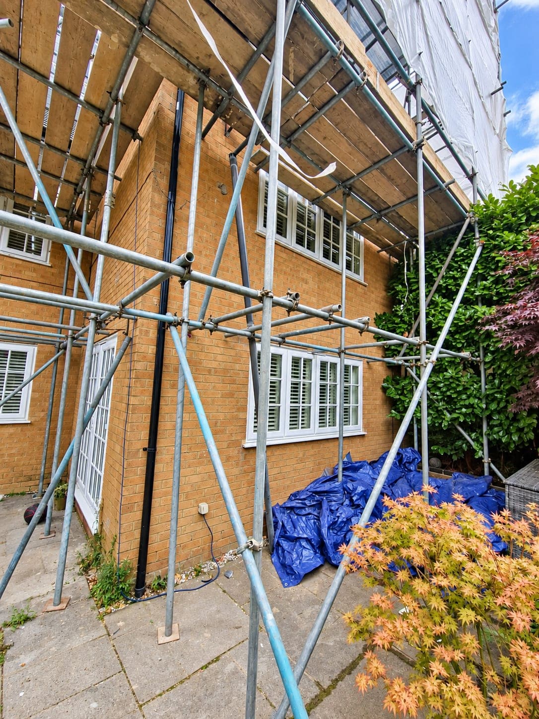 Brick side elevation of a detached house before rendering, London